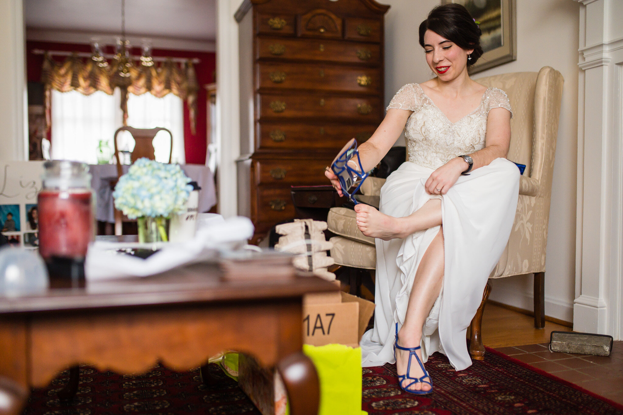 The bride putting on her wedding shoes 