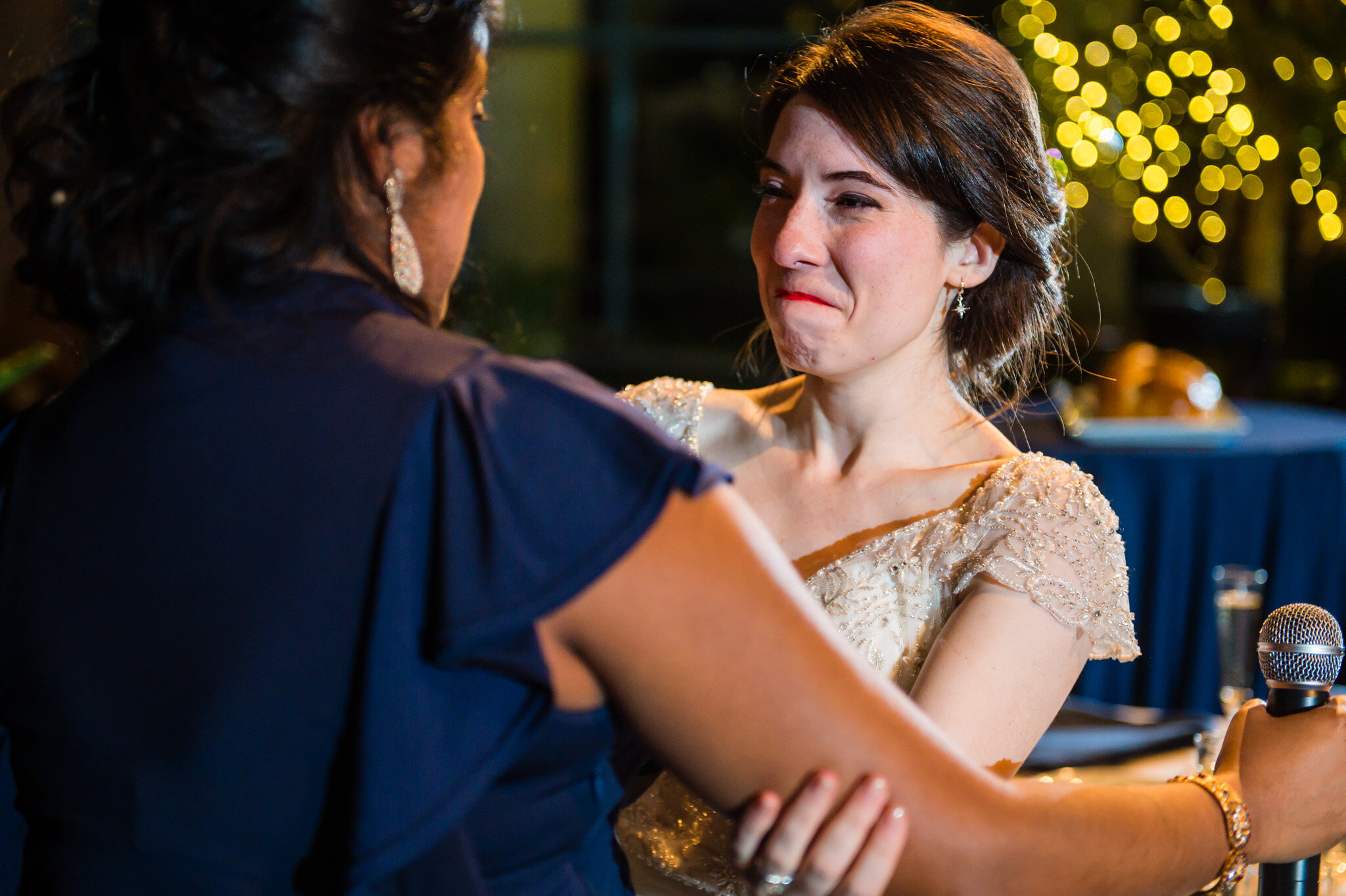 The bride gives her maid-of-honor an emotional joy-filled hug