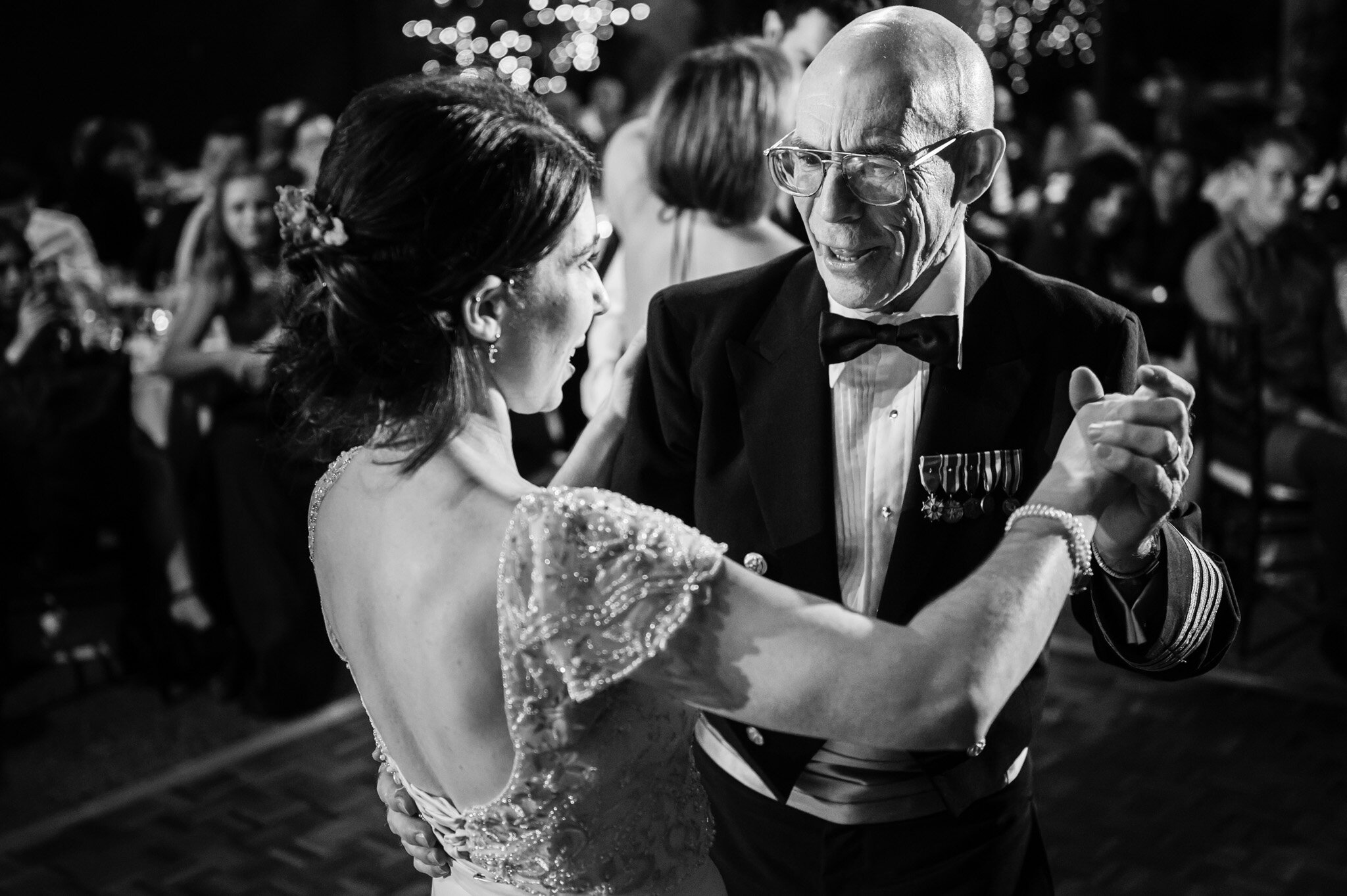 The bride and her father share a dance together at her wedding reception
