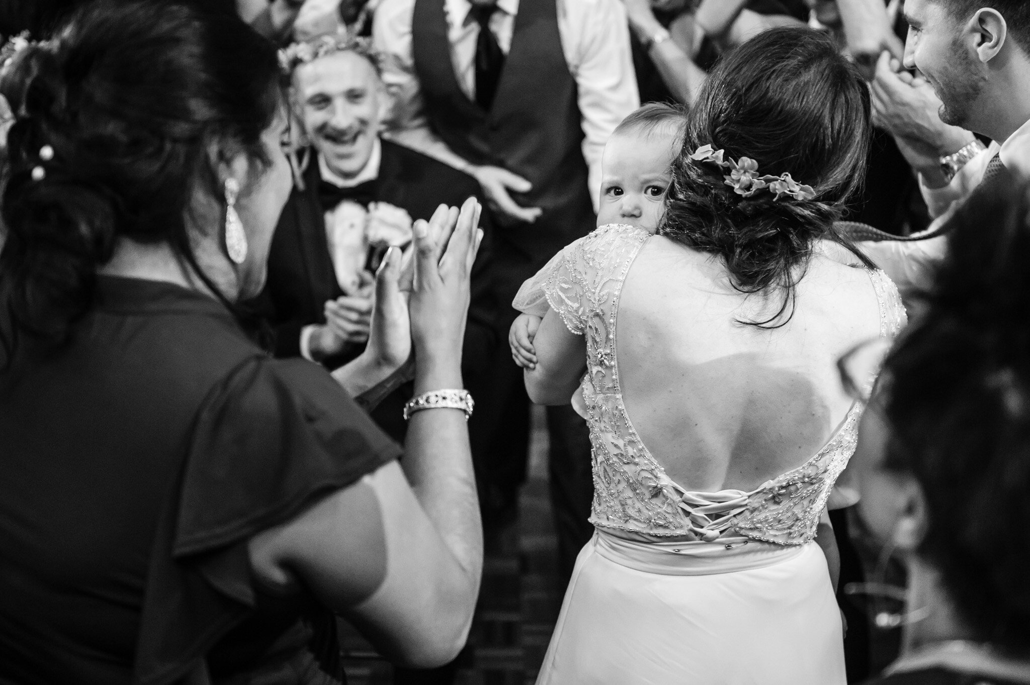 The bride dancing with a small child at her wedding reception