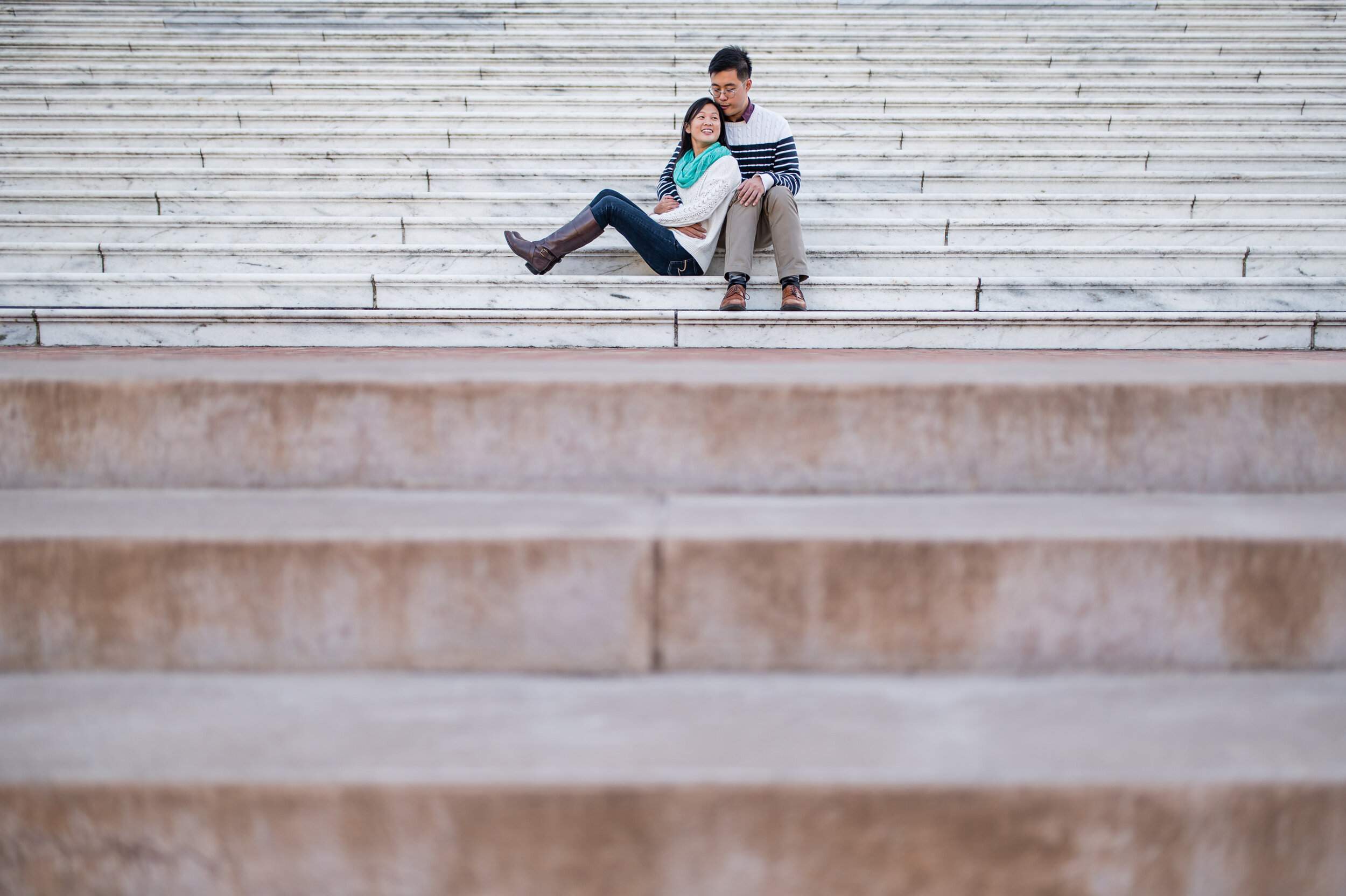 couple sitting on steps during their engagement session at UVA