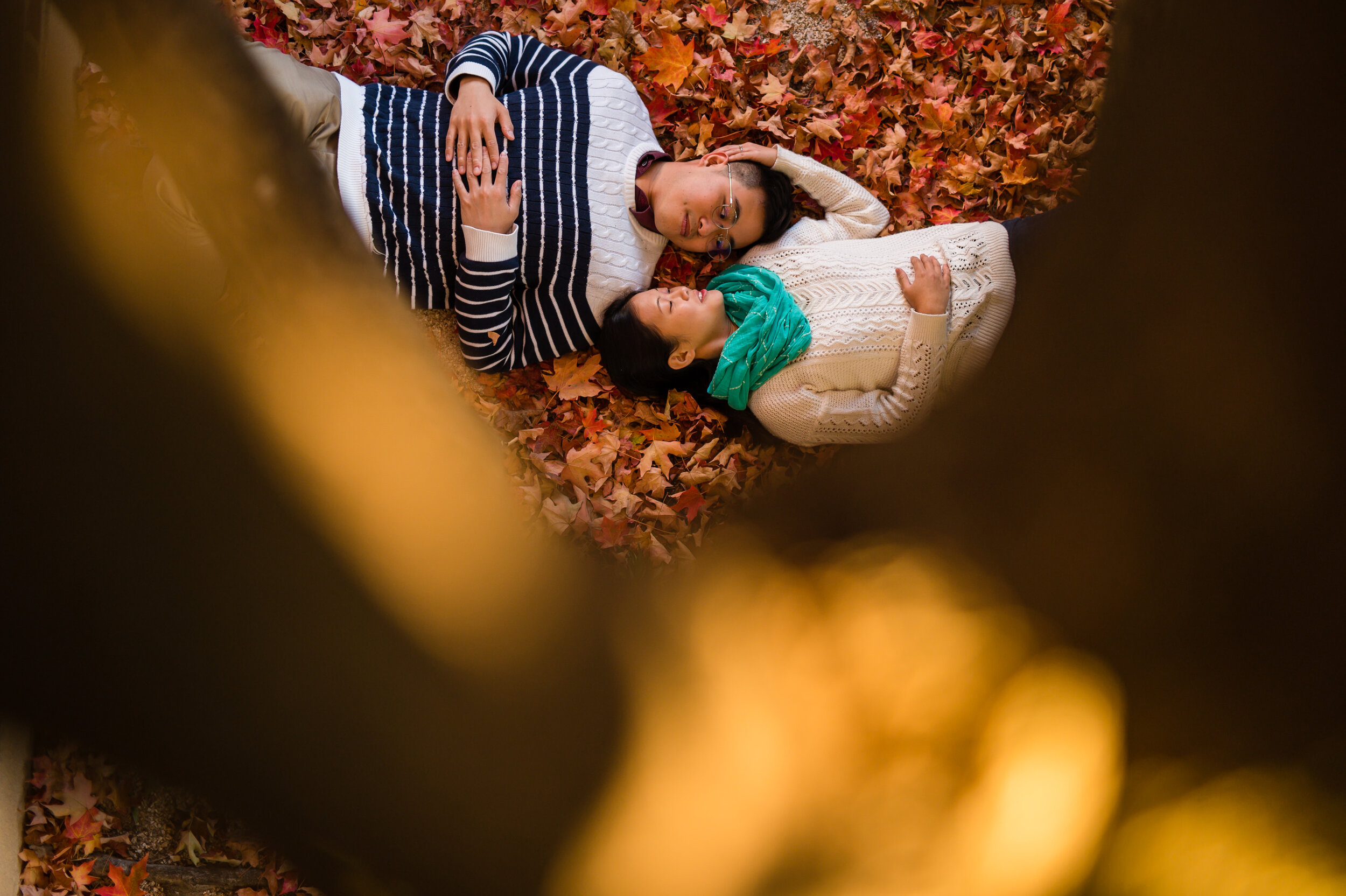 A couple lies on the ground during their fall engagement session