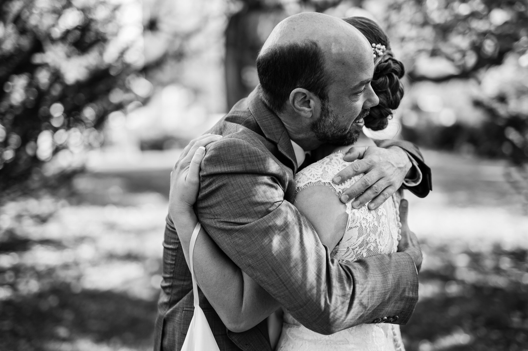 Black and white of wedding couple embracing