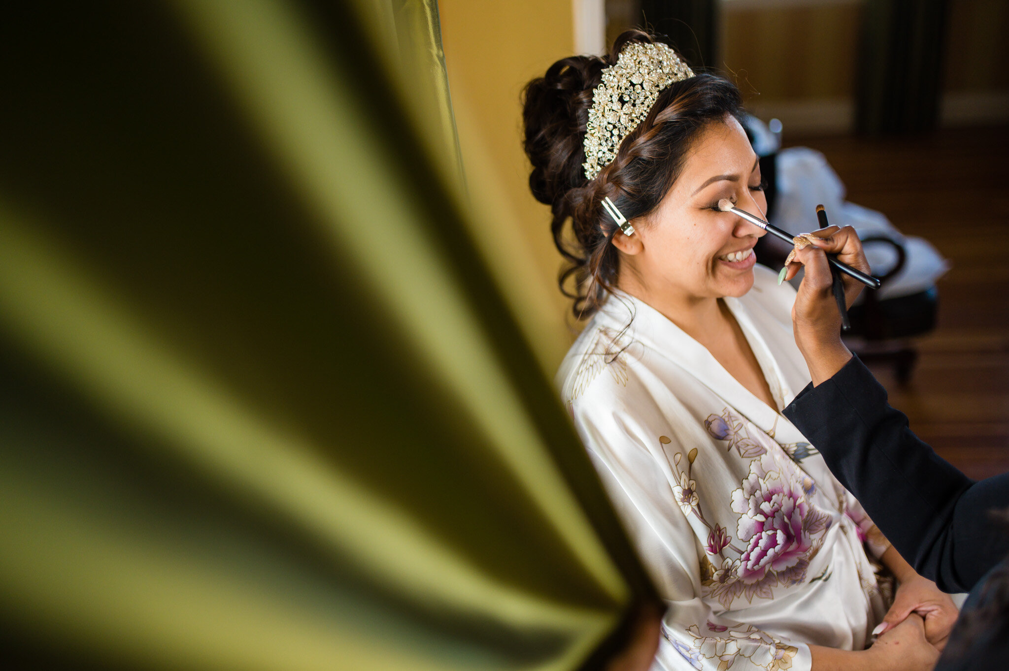 Bride putting on her makeup before her wedding at Belmont Country Club