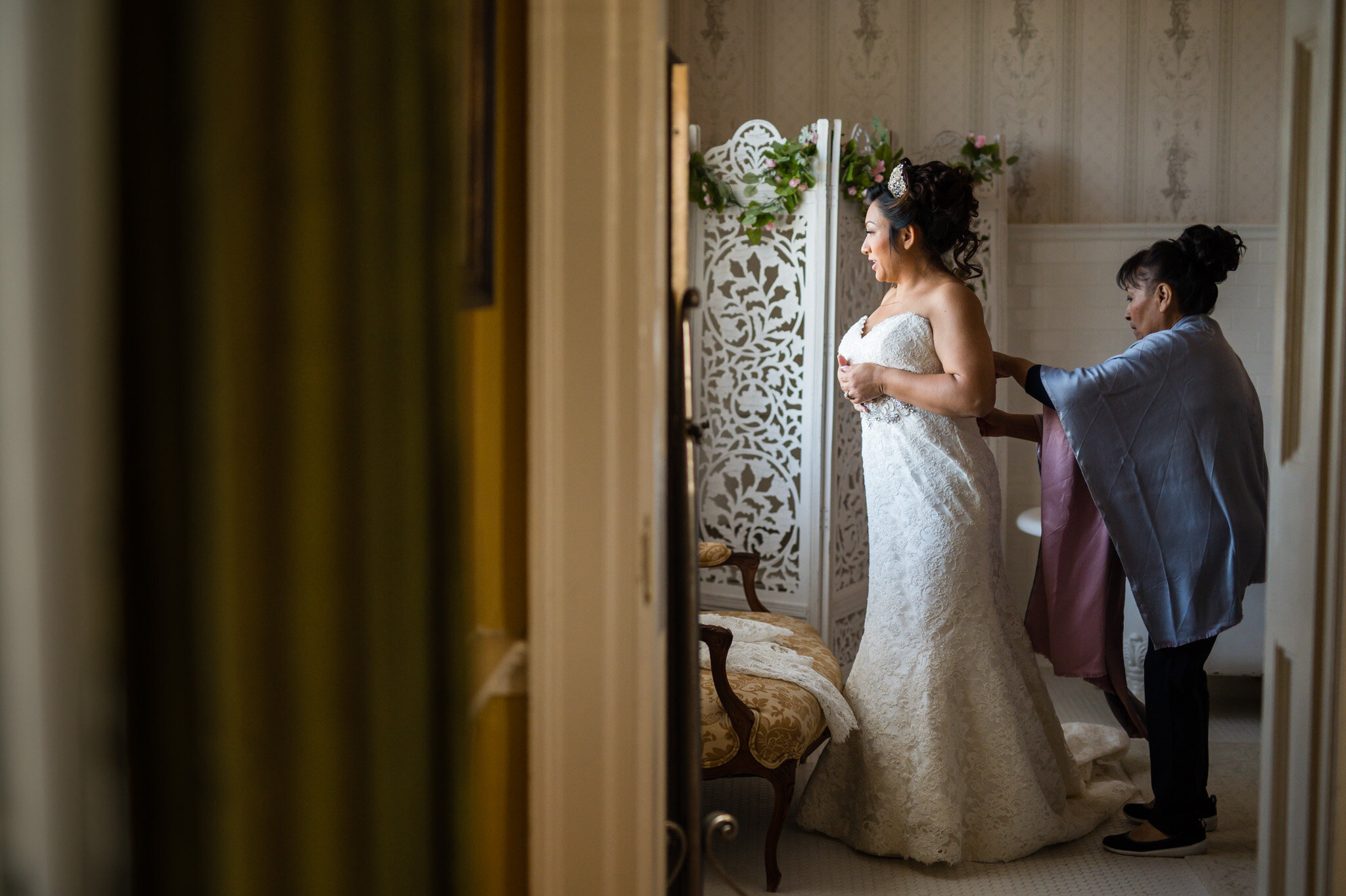 Bride putting on her dress at Belmont Country Club