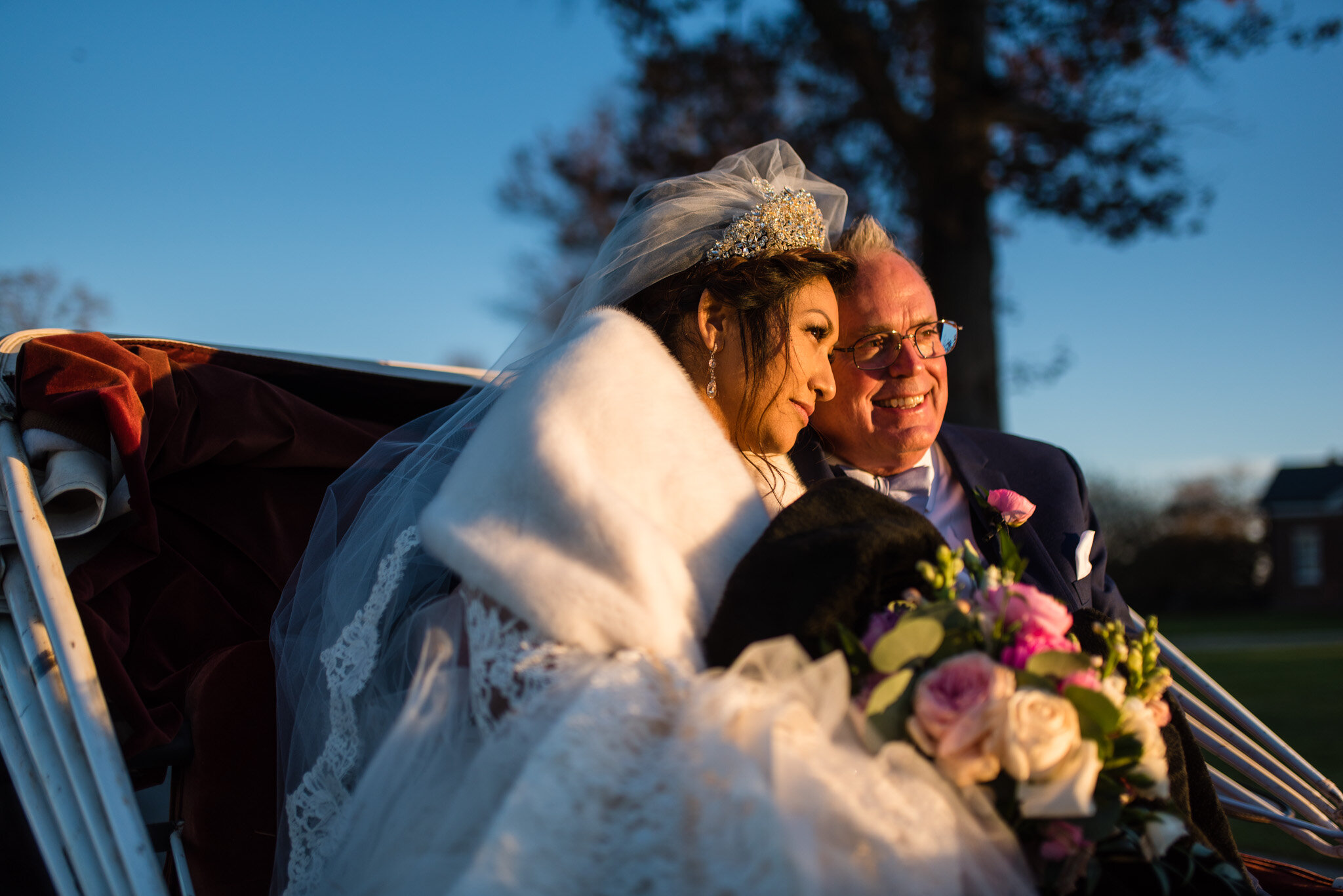 Bride and groom enjoying time together in a horse drawn carriage