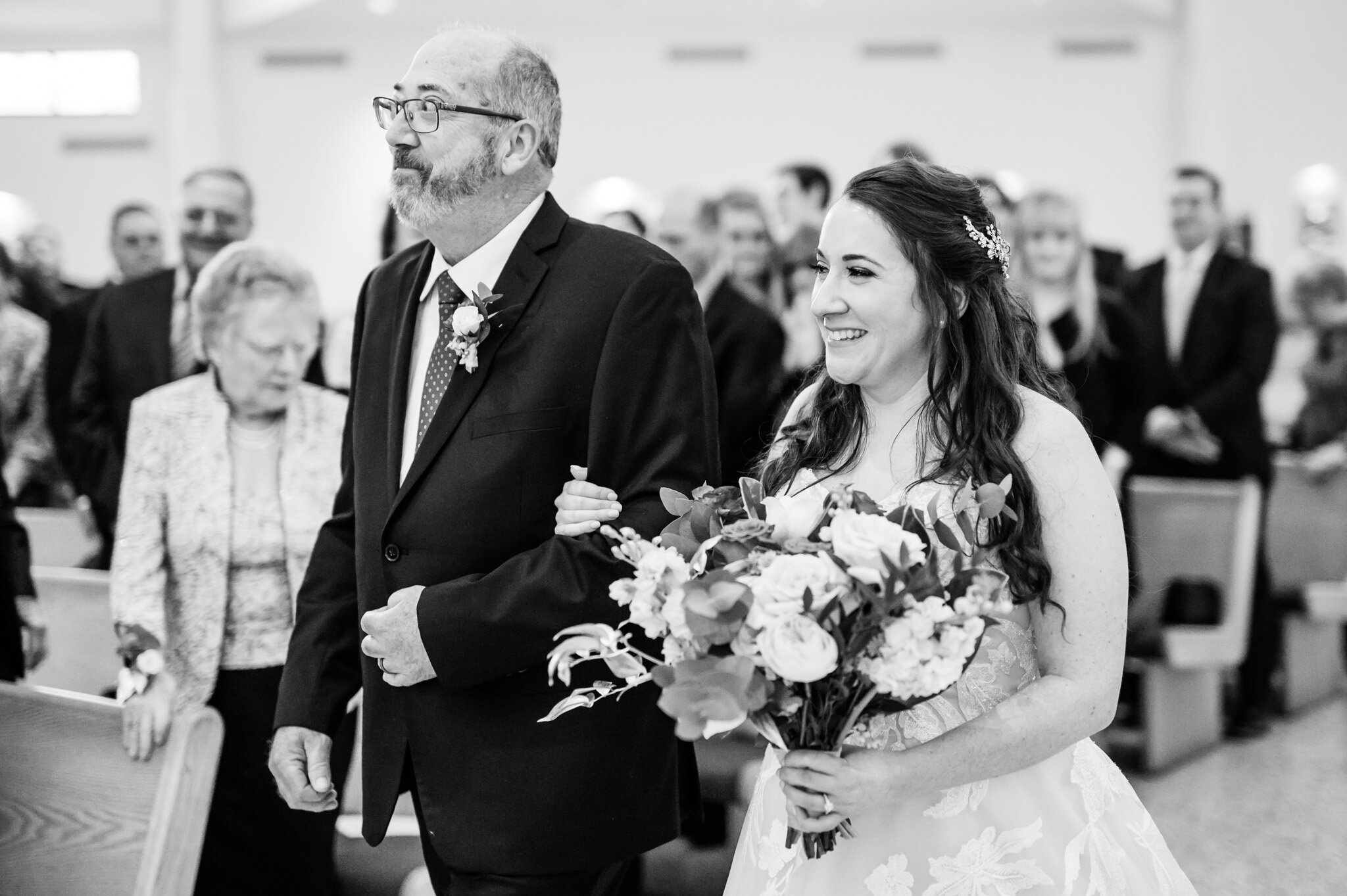 Father and bride walking down the aisle.