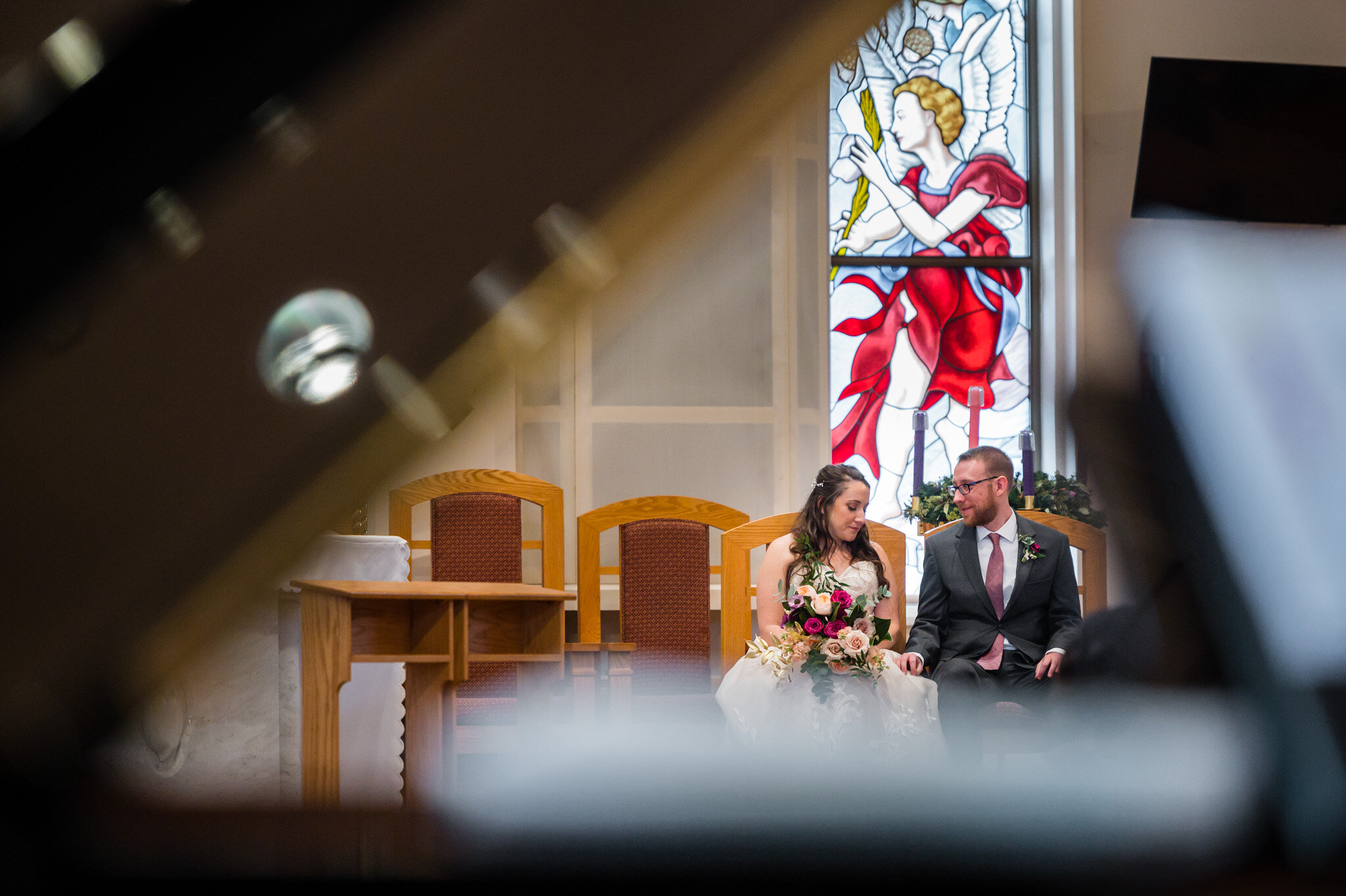 The bride and groom sharing a quiet moment during their Catholic wedding ceremony.