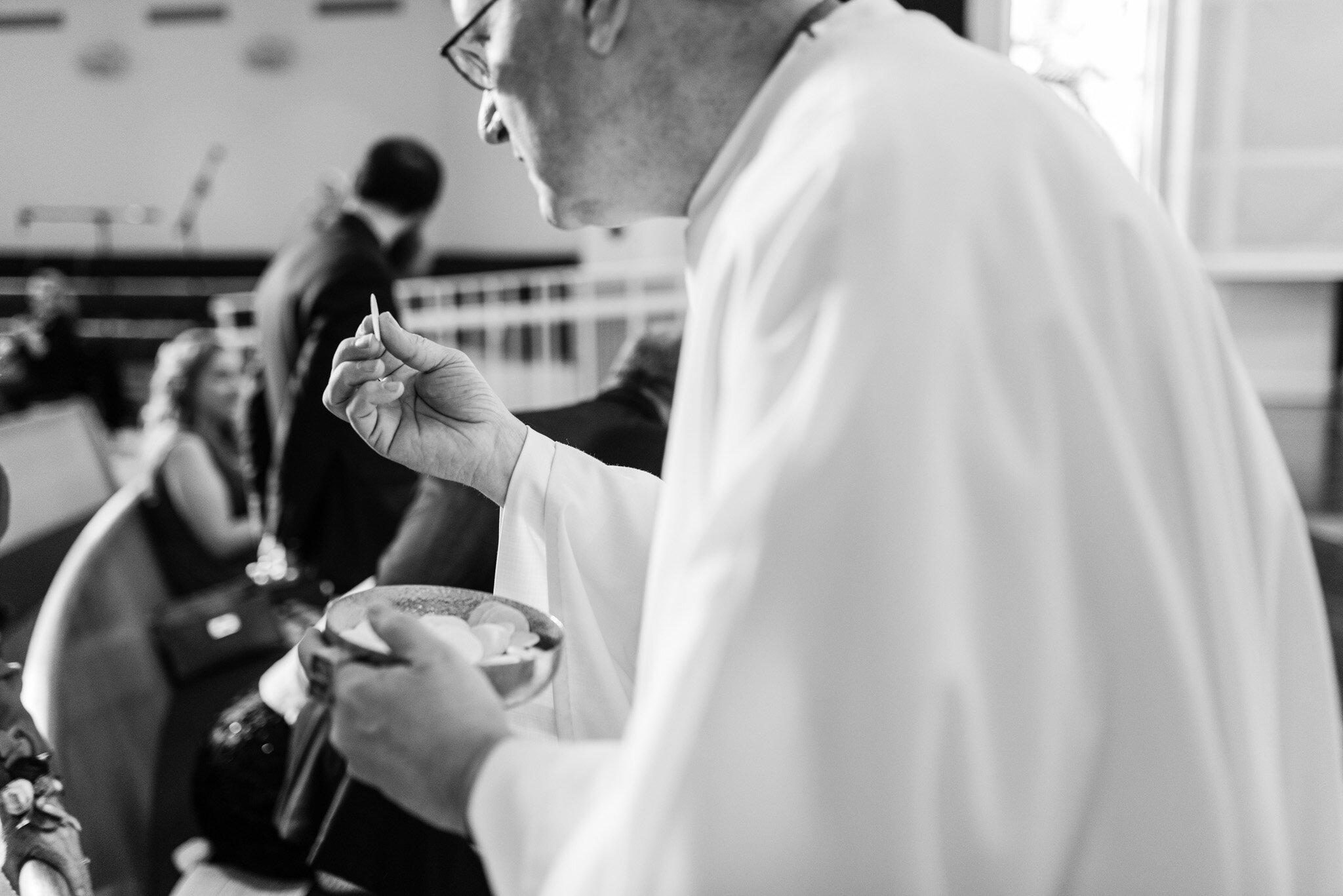 Catholic priest administering communion