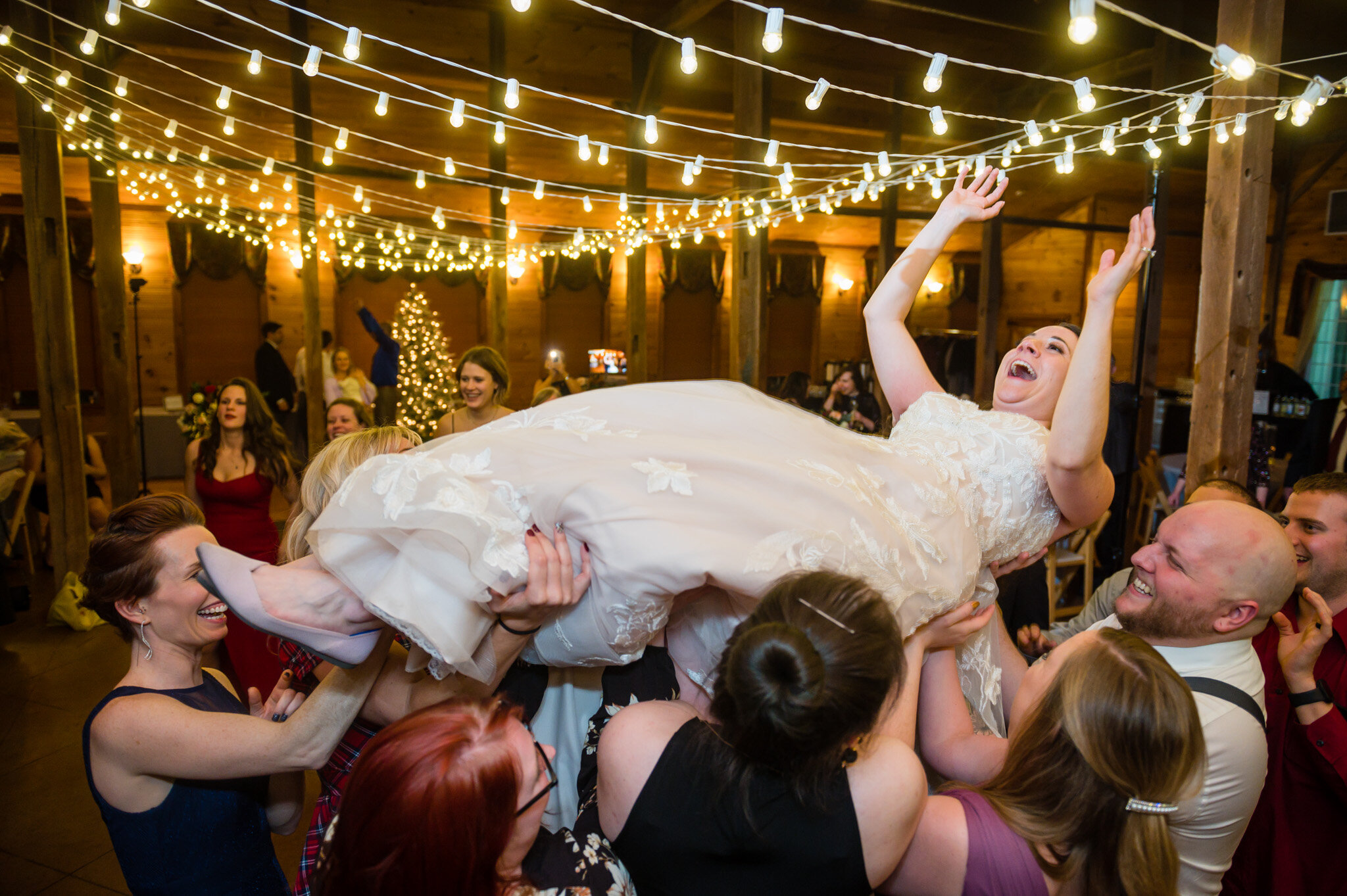 bride being carried at wedding reception