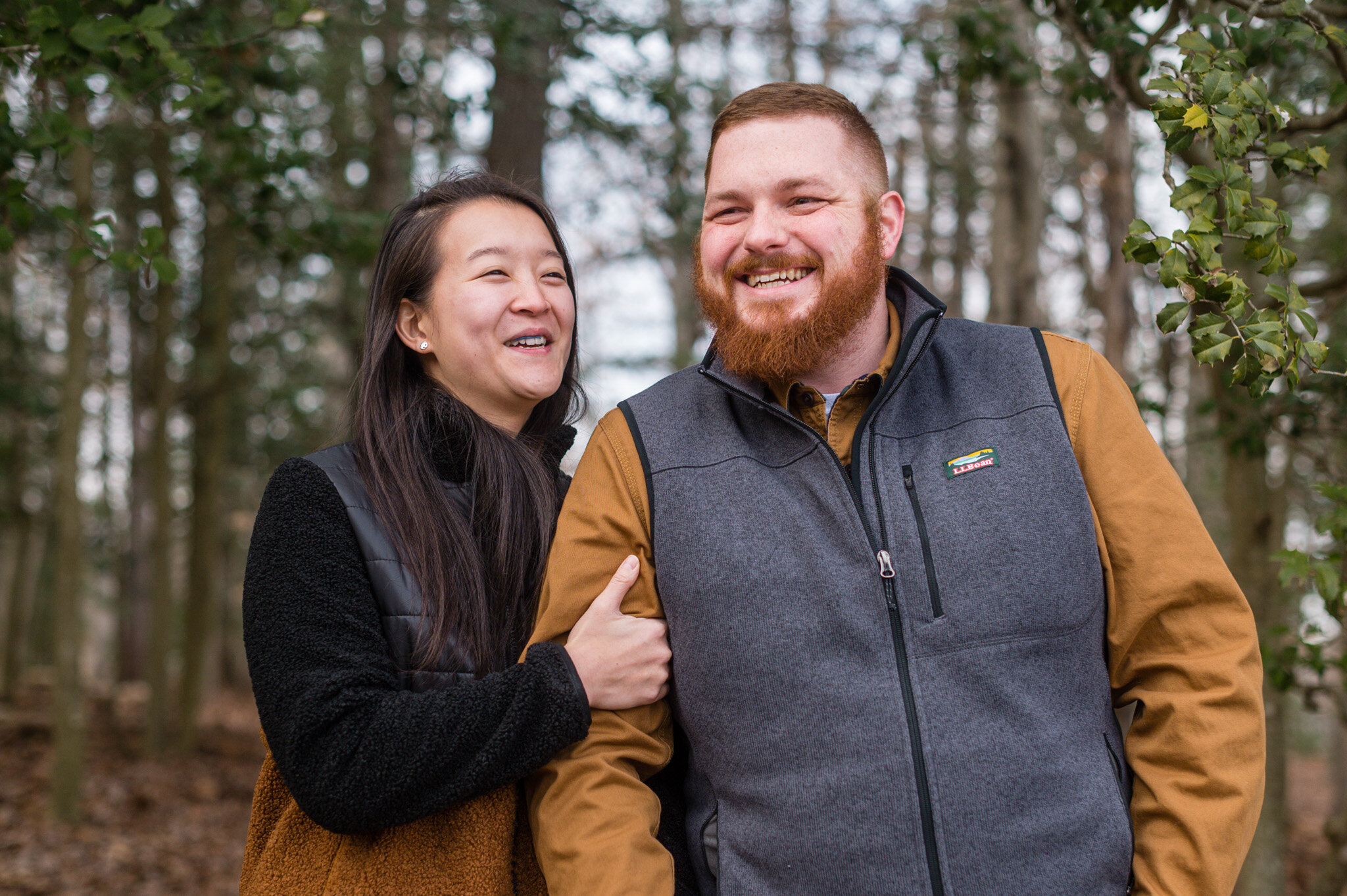 Couple laughing together during their engagement session at Burke Lake