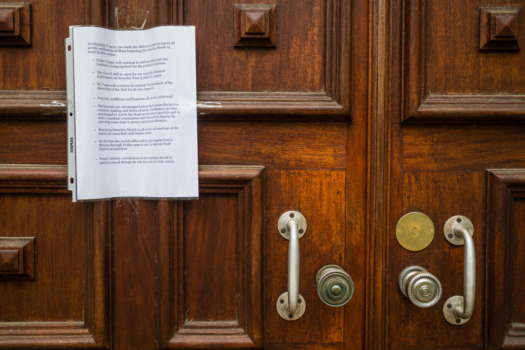 A notice about COVID-19 on the door of the church