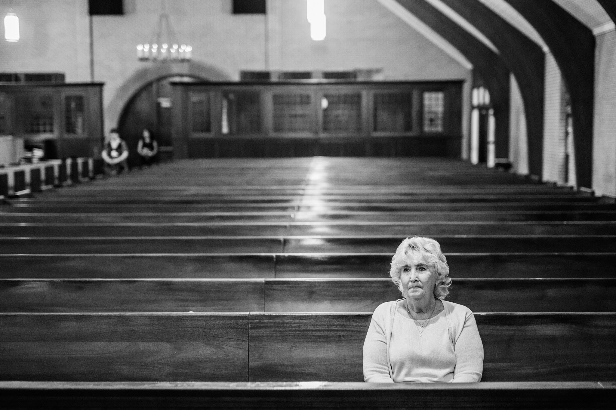 A single guest sits to enjoy the wedding ceremony