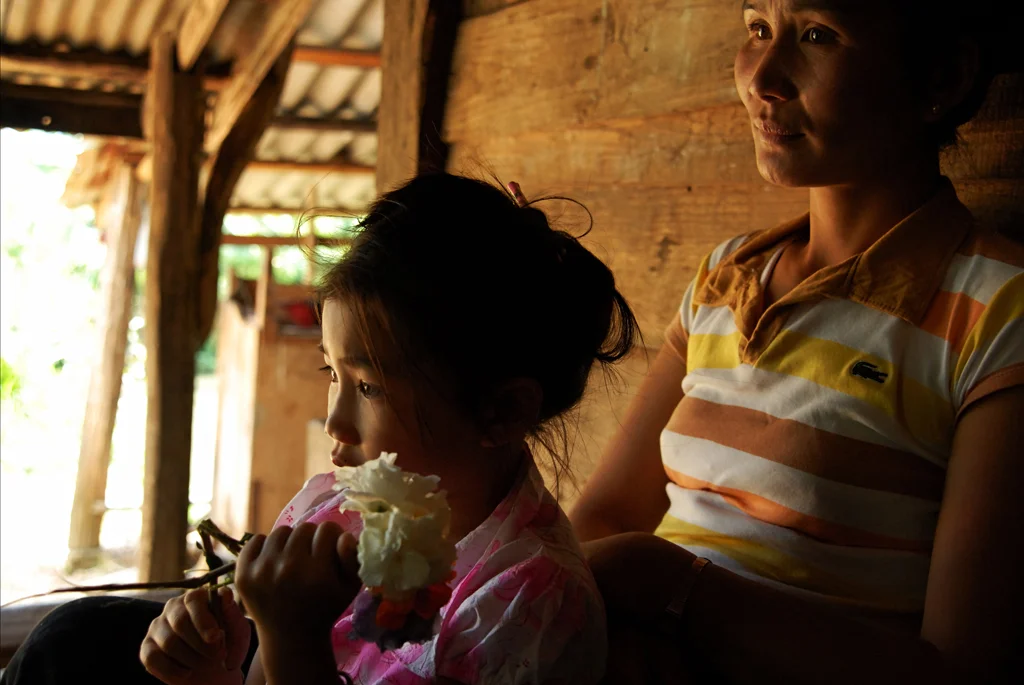 A mother and child relax in their home in Xieng Khouang Province, one of the most heavily
bombed areas in Laos.