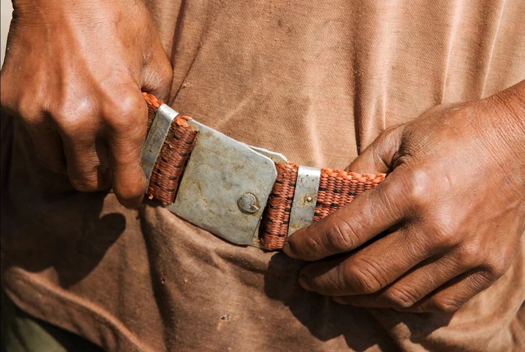 “For one week following the accident - in complete darkness – you could still see me, similar to a
light.”
Lone - 47 years old - was injured as a boy in 1979 when he found a canister containing cluster
bombs filled with white phosphorus. Lone’s belt is made from UXO. Savannakhet Province, Laos
