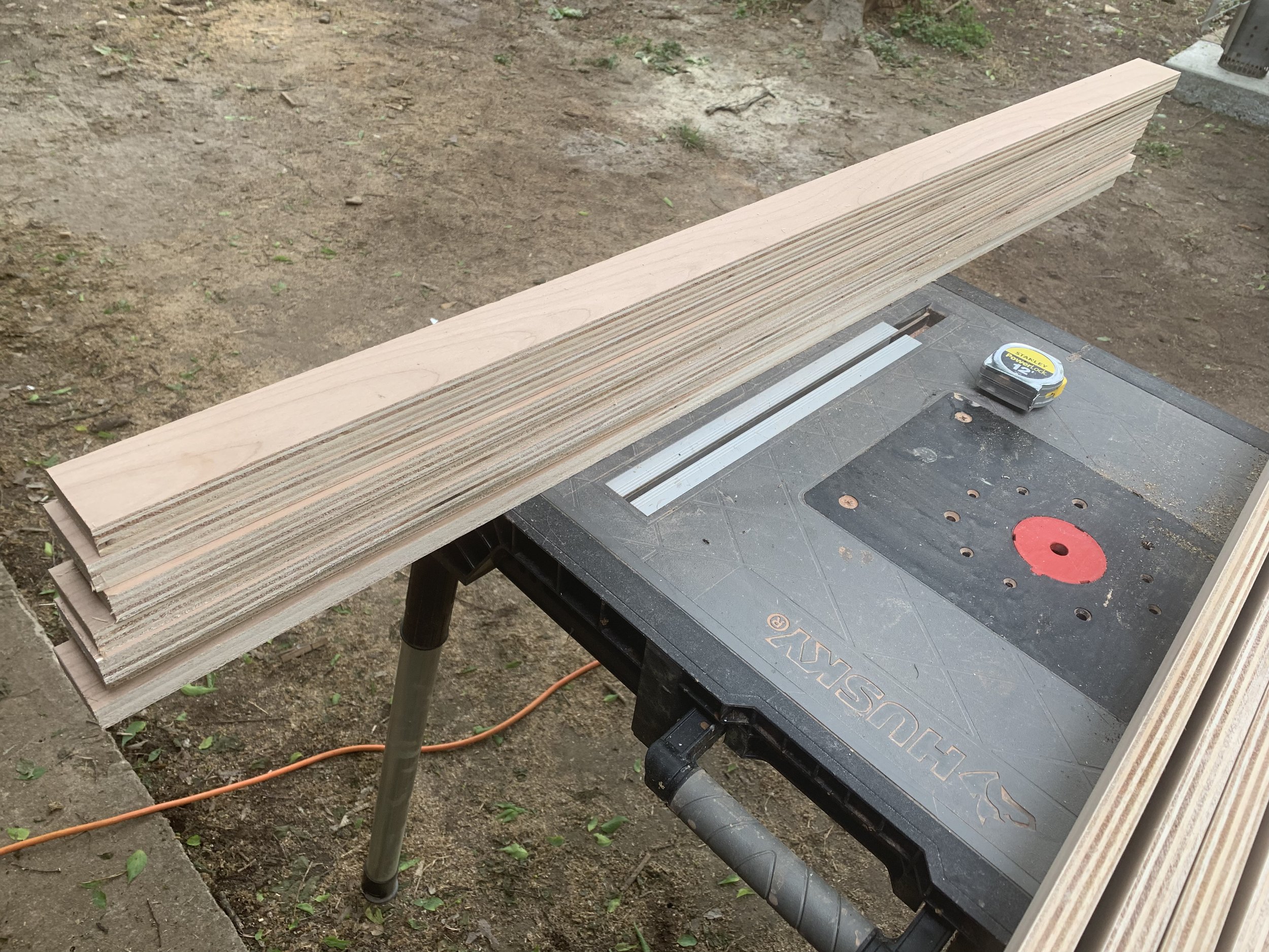  Our next job was to cut the well pieces exactly to fit. One edge was the factory edge, and the other was our rough. We had to line them all up with the factory edge to get a perfectly straight line. Then, we could get an exact cut on the mitre saw. 