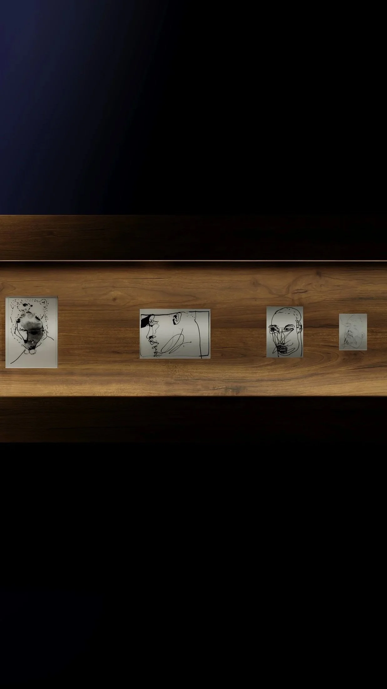 Four minimalist line art portraits by british artist Jonathan Joubert of faces displayed on a wooden surface against a dark background.