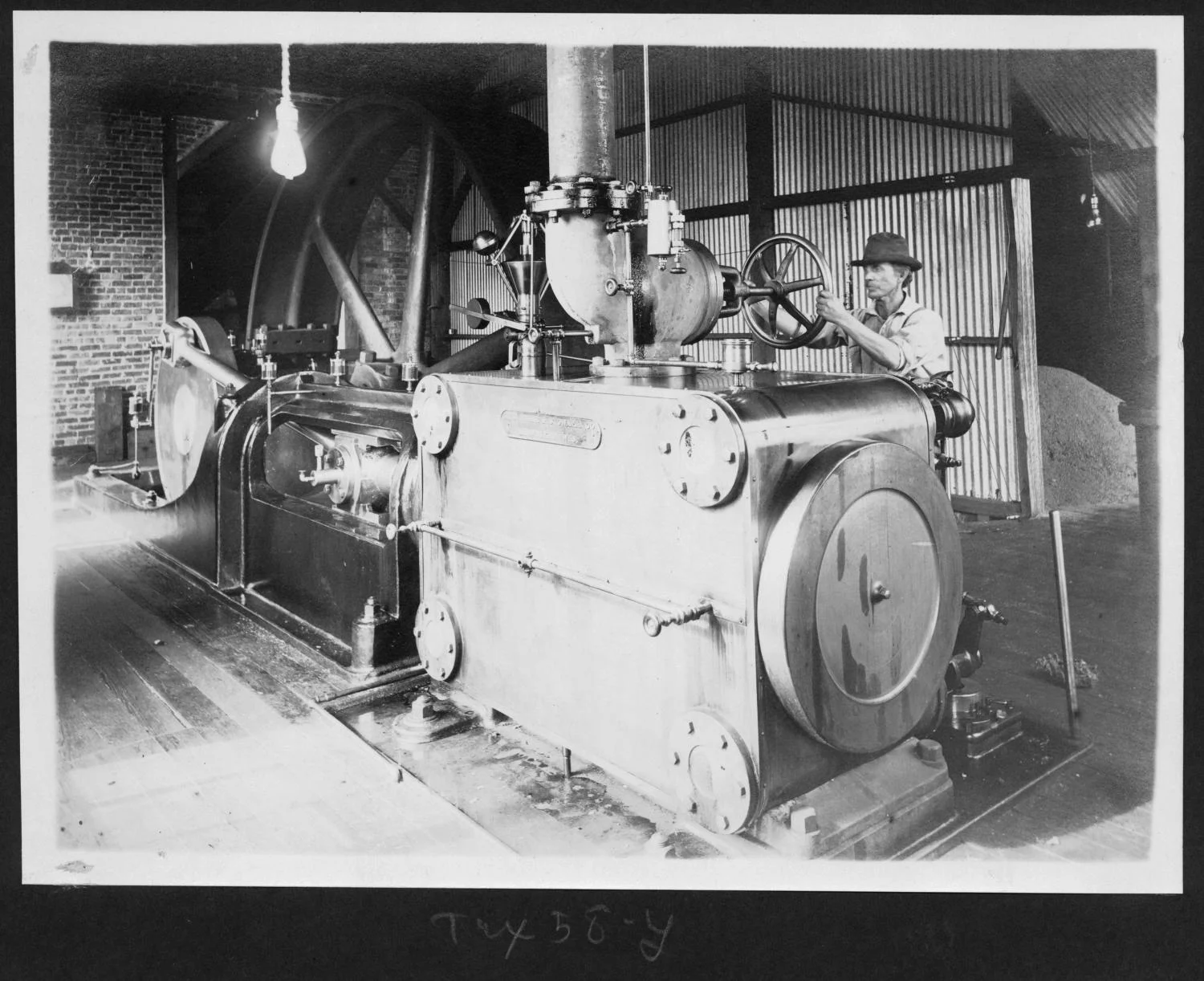 Tex58 Worker with Machinery Inside of the Mill