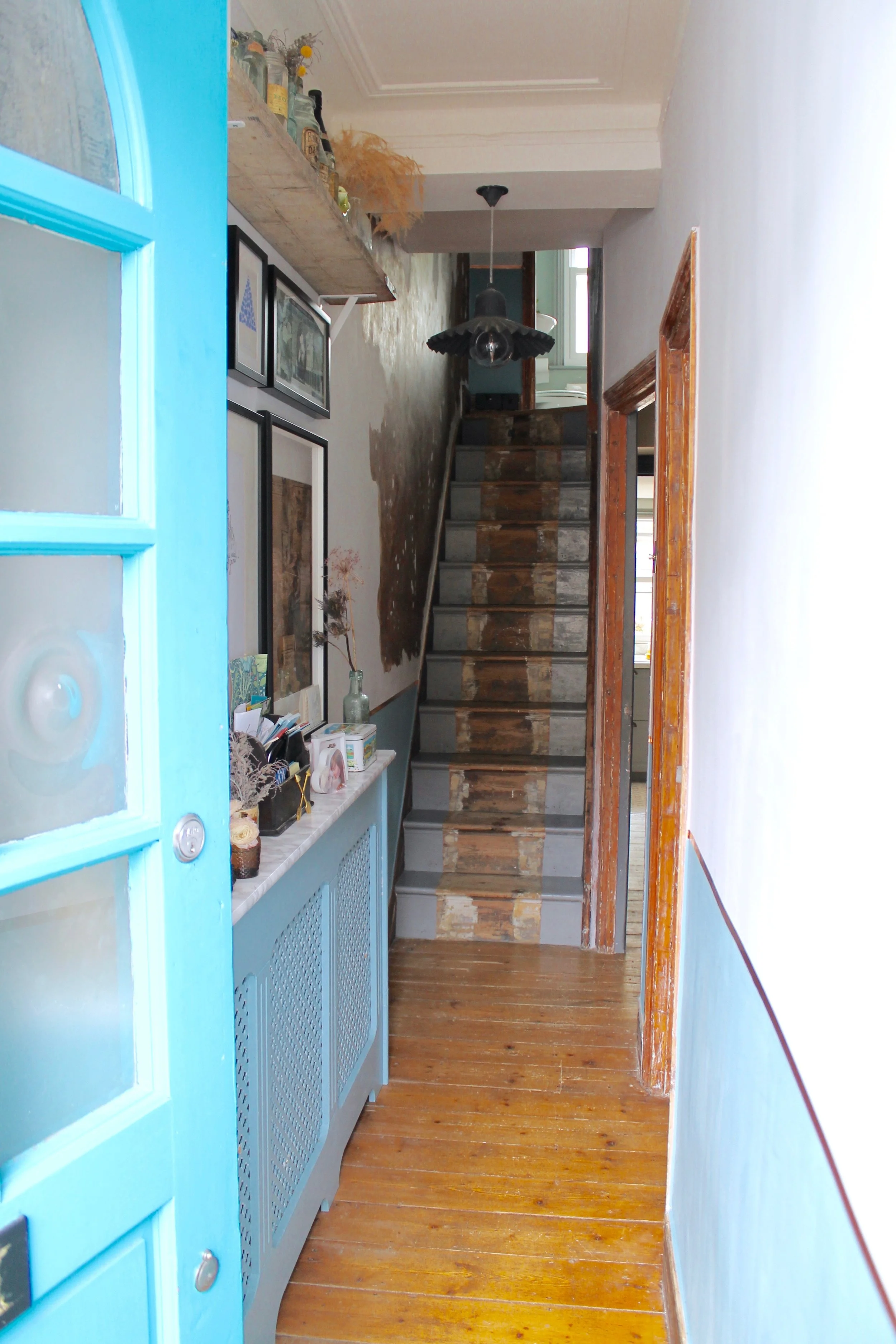 Photography provided by Joanna Thornhill - Entrance to my home showing the copper tape in place of a traditional dado rail (my house is an 1890’s Victorian terrace in Walthamstow, north-east London). The high shelf is an old scaffold board where I’ve showcased loads of old Victorian bottles and jars that the builders found under the floorboards! 