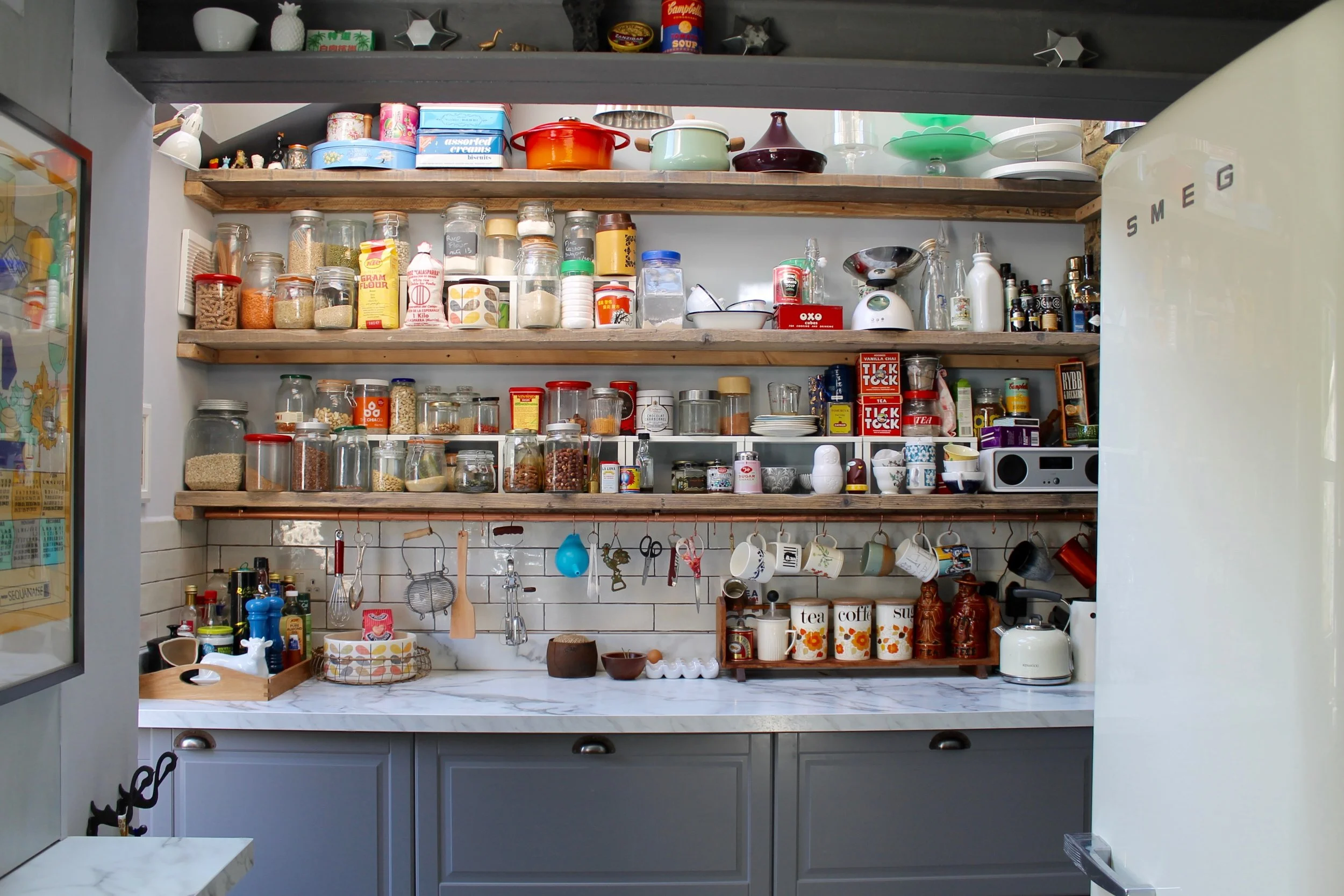 Photography provided by Joanna Thornhill - New kitchen extension integrates into the period style of the house by bringing in warmth with old scaffold boards as shelving, a copper hanging rail and vintage styling as well as leaving some of the old brick and beams exposed