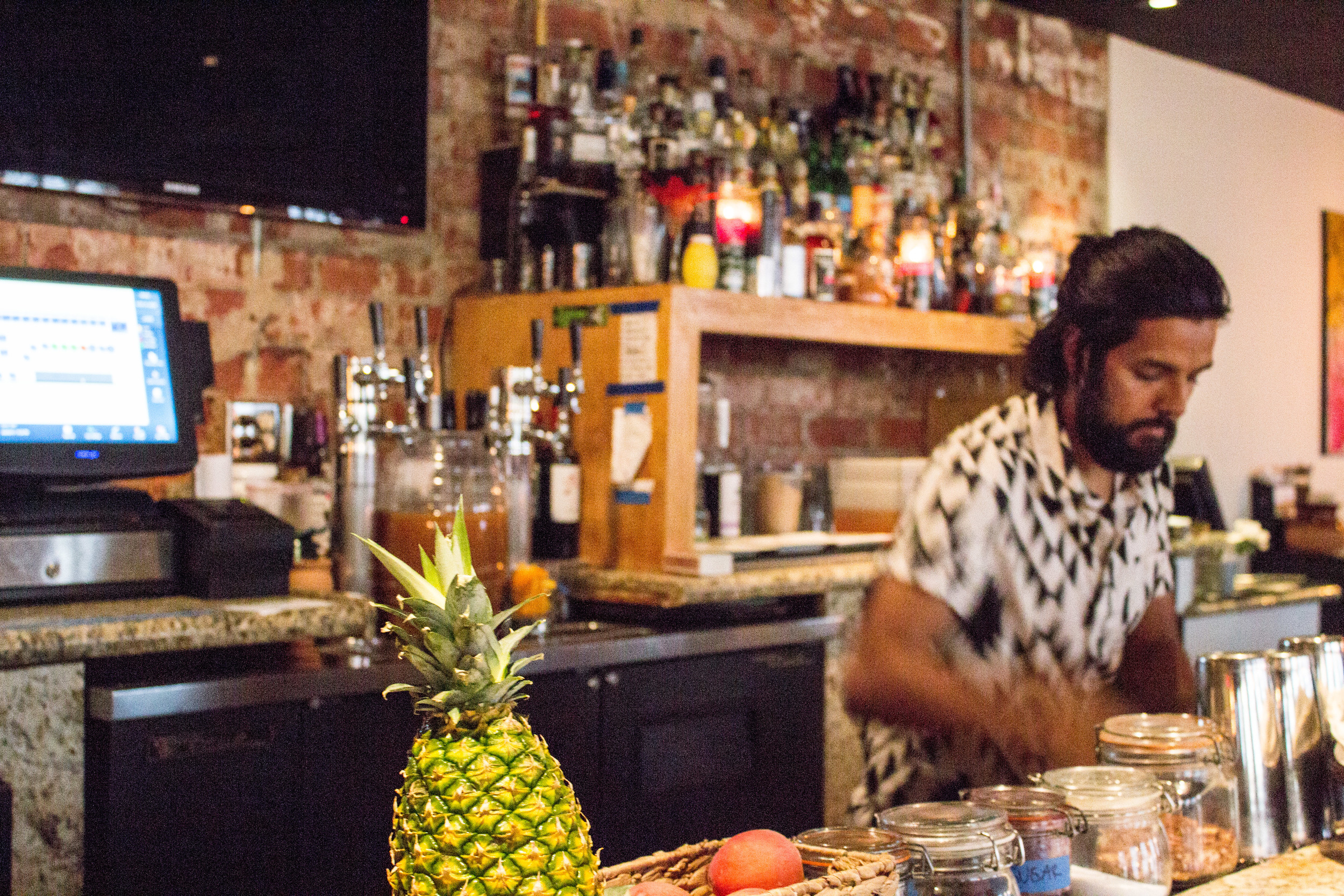 Bartender and co-owner of Corazon y Miel Robin whips up refreshments at the bar.