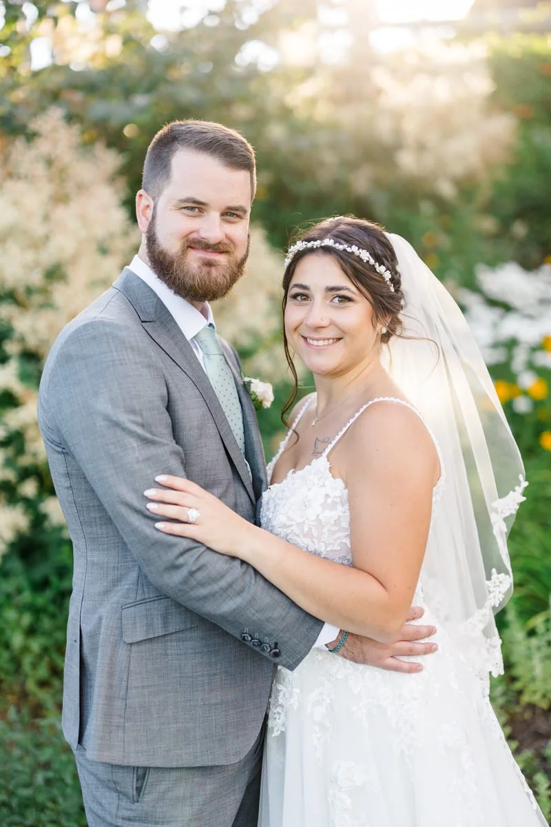 Bride and groom smile during portraits after their wedding at at Mountain Top Inn Vermont