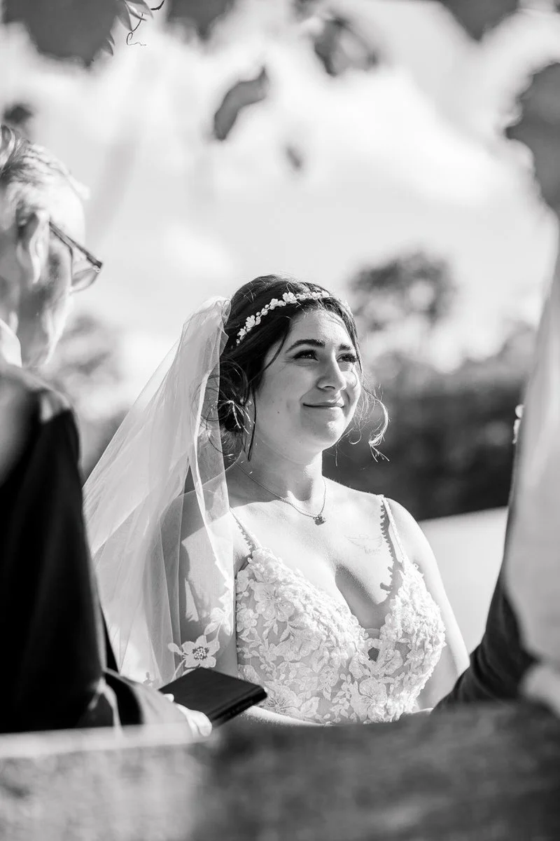 Bride smiles at groom during ceremony at Mountain Top Inn Vermont Wedding