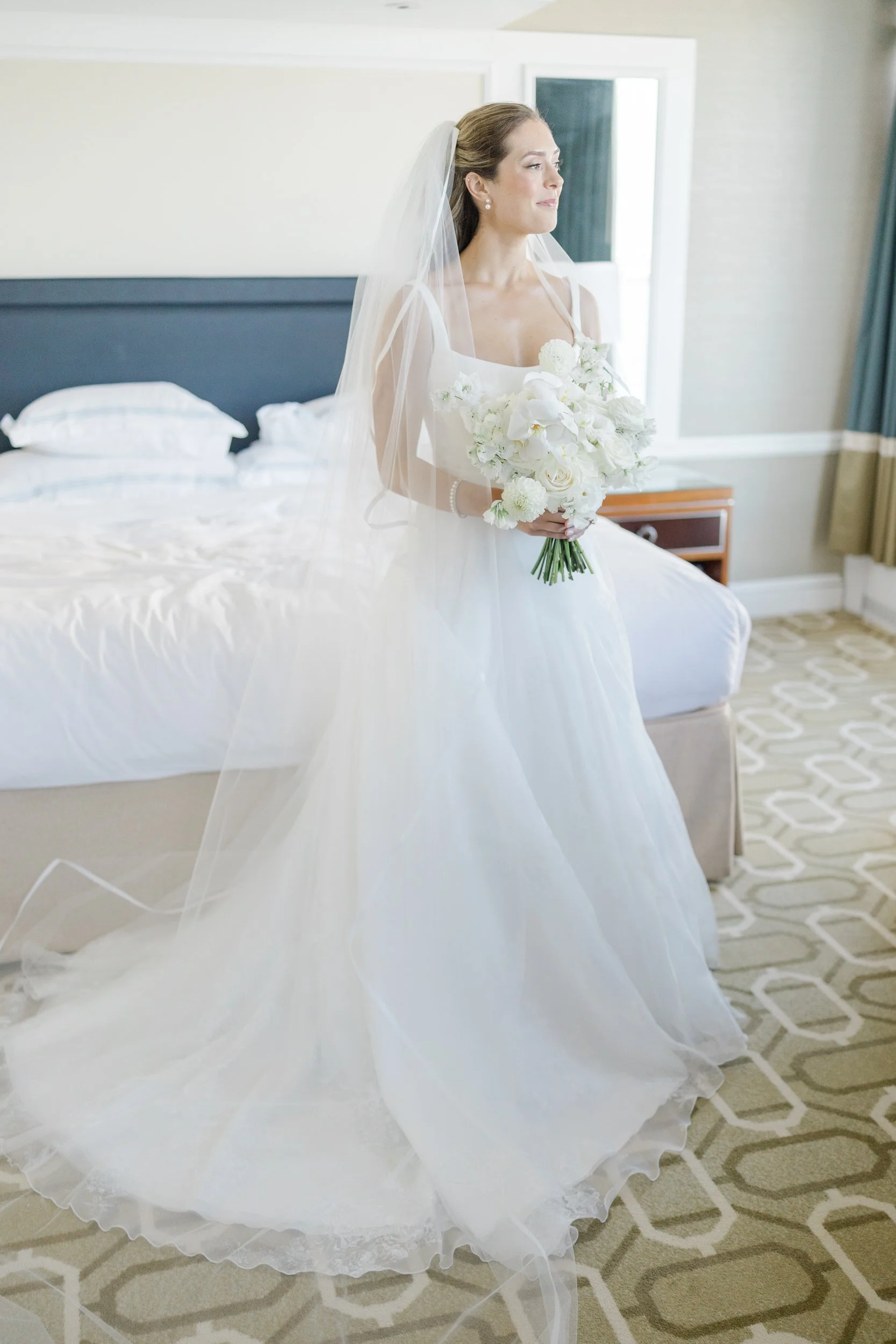 Bride puts on her wedding dress  at Boston Harbor Hotel Wedding