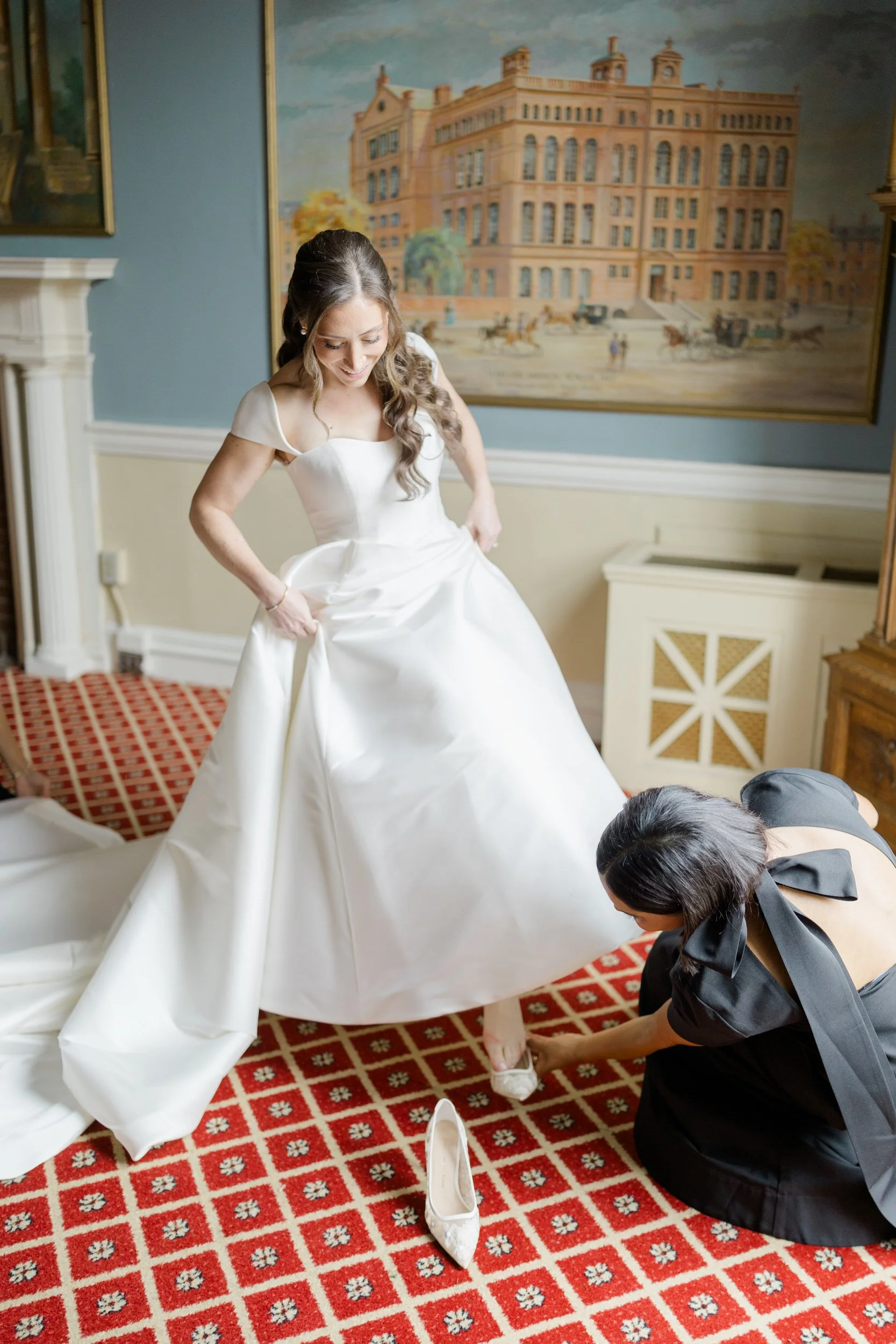 Bride puts on her shoes at the Harvard Club of Boston Wedding