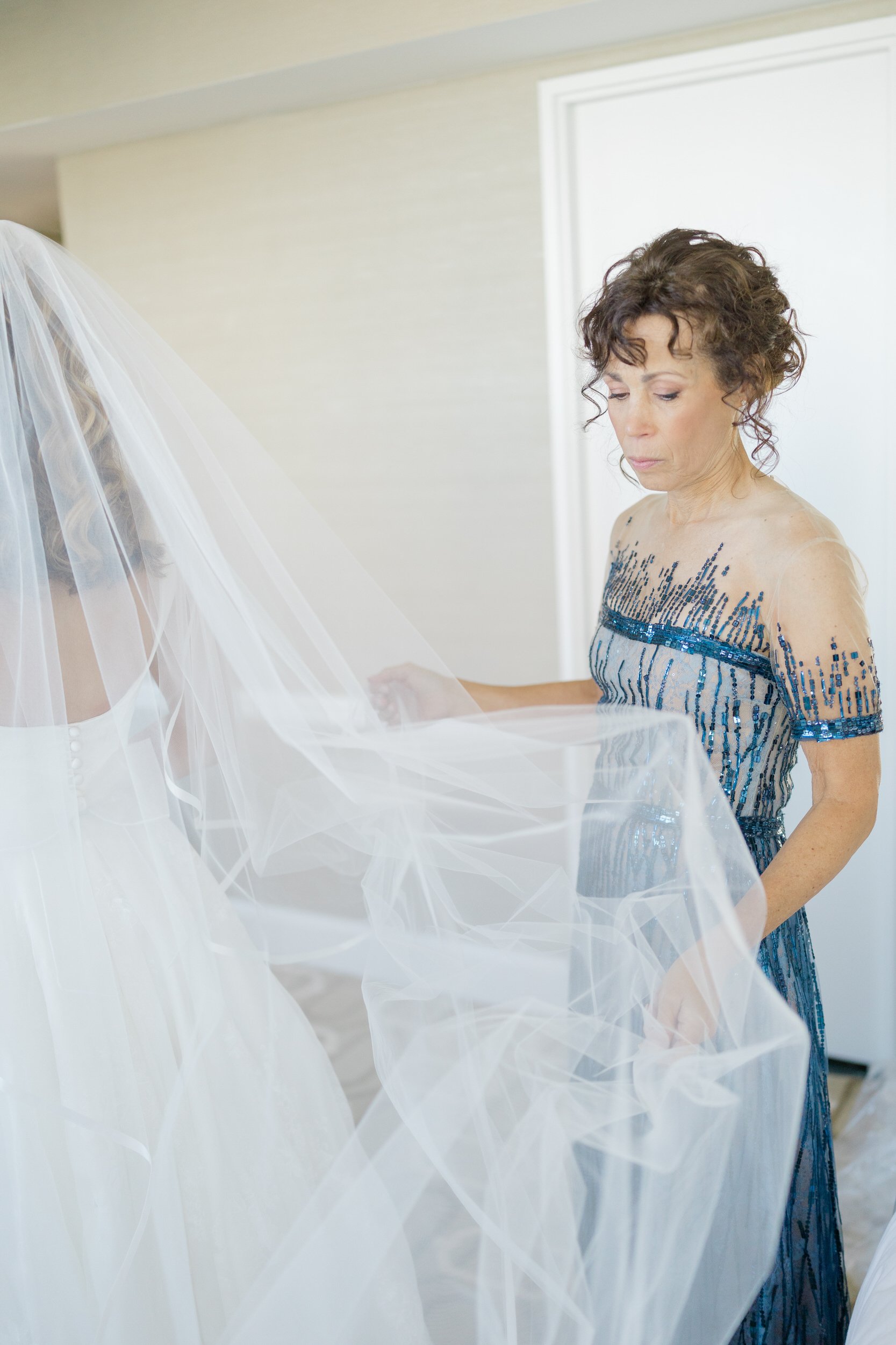 Bride puts on veil  at Boston Harbor Hotel Wedding