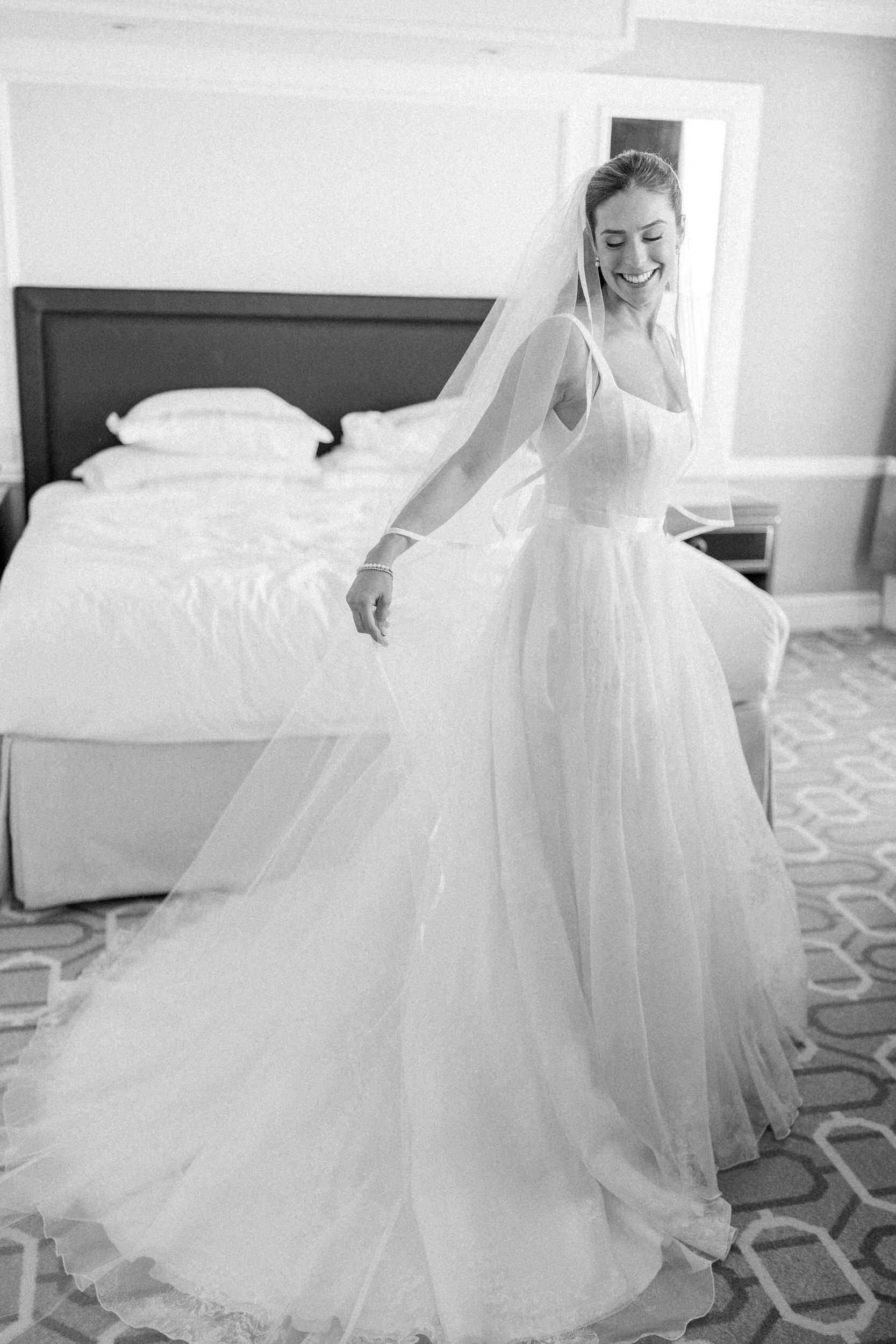 Bride smiles in her wedding dress  at Boston Harbor Hotel Wedding