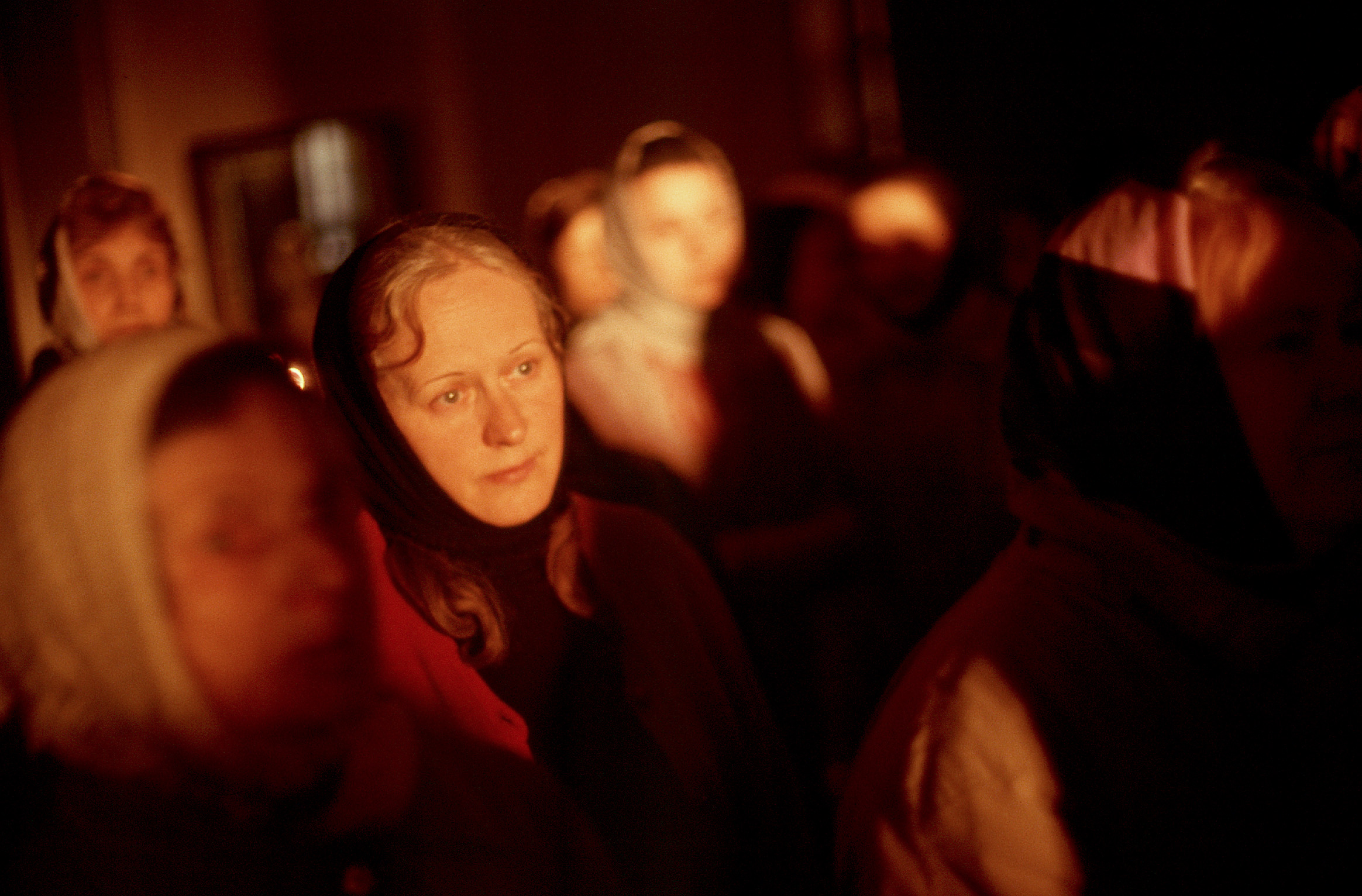 Morning sunlight illuminates the face of this pilgrim near the end of the all-night Easter service held at the monastery's cathedral. 