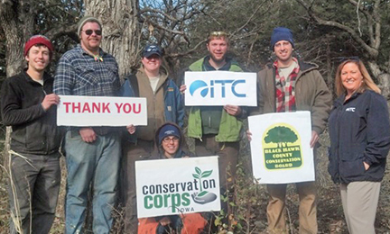 Iowa corps members thank ITC for funding restoration work at Cedar Bend Savanna near Cedar Falls, Iowa. Standing, from the left are: Andrew Montgomery, Scott Cressler, Allison McIntosh, Ian Wolf and Josh Bruecken.&nbsp; On the right: Angela Jordan, ITC area manager, and in the front: Tracey Prenger, crew leader.