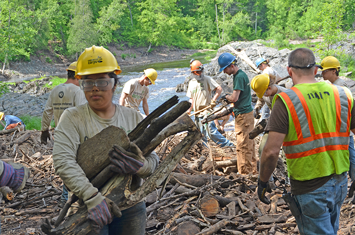 Field crew members and SYC participants, including Helen Juarez carrying sticks, worked side-by-side to clear a logjam at Jay Cooke State Park.
