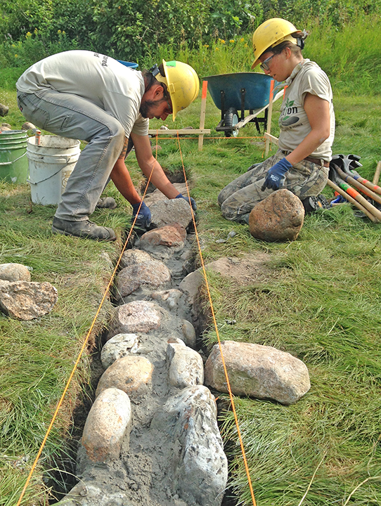 Jacob Roman and Taryn Orona constructed the stone foundation for the log shelter at Coffee Pot Landing.