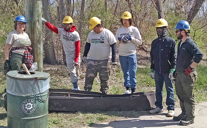 The Minneapolis North Commons crew posed by a huge piece of metal debris they retrieved from the banks of the Mississippi.&nbsp;