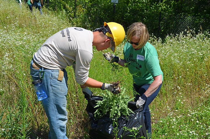 Summer Youth Corps crew member Mason Anderson and Andersen Corporation employee Patti Savage bagged invasive plants removed from the Boom Site.&nbsp;