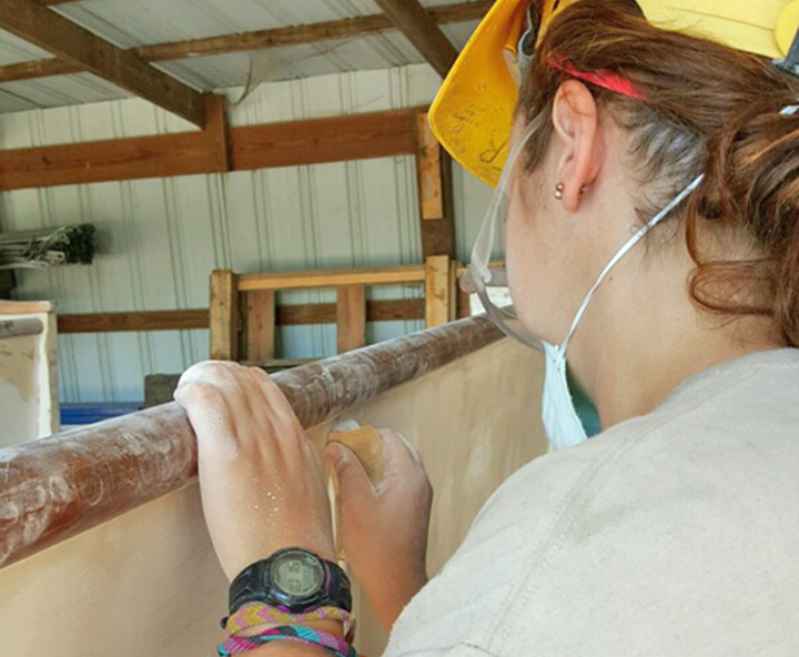 Maren Schwenzfeier sanded a church pew while serving on a HOPE crew at the Lincoln Boyhood National Memorial in Indiana.