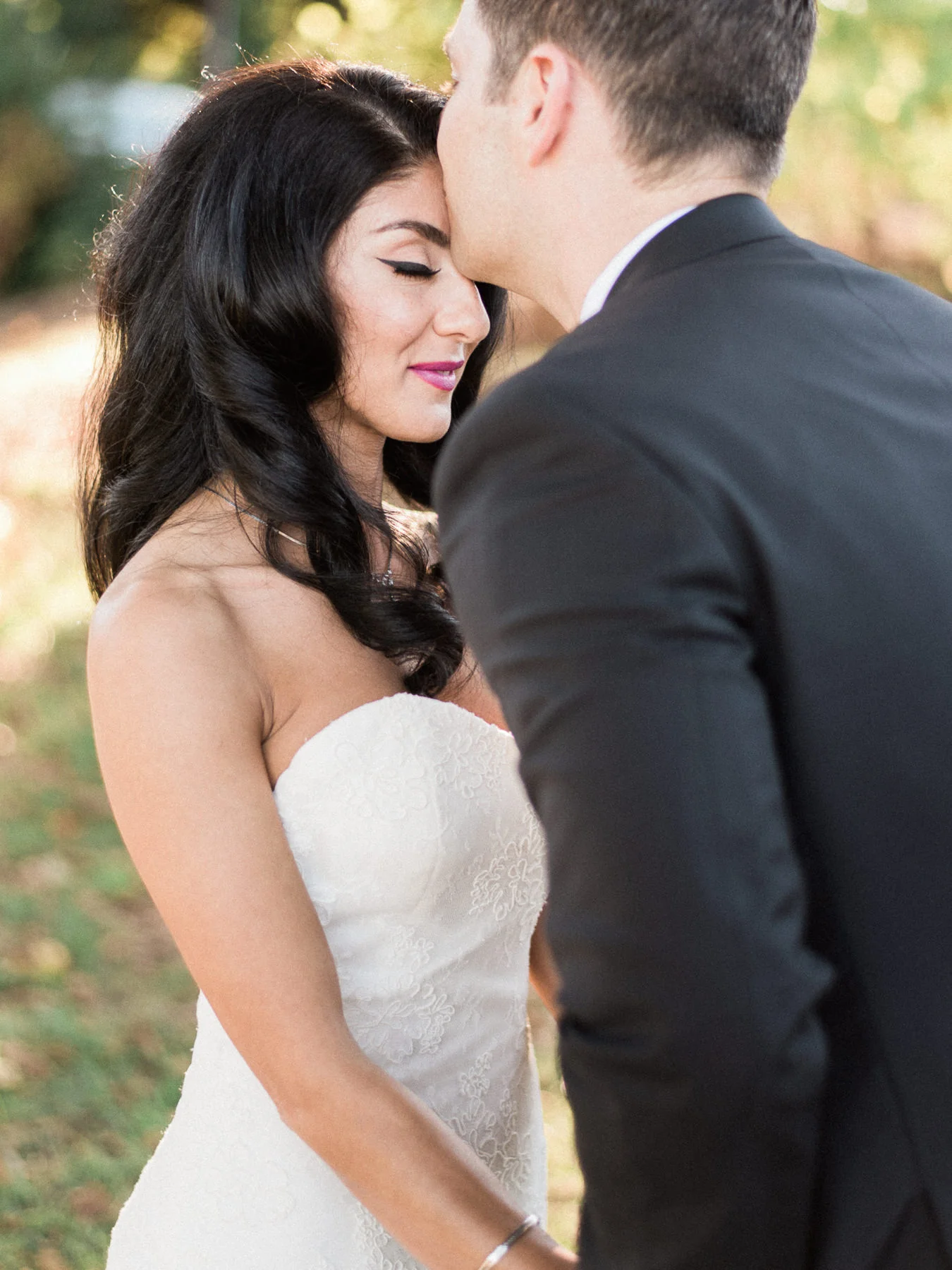 Groom kisses bride at first look