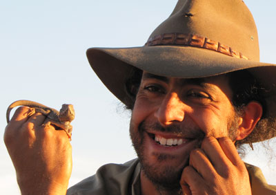 Ecologist George Madani displays a small reptile, 2010.