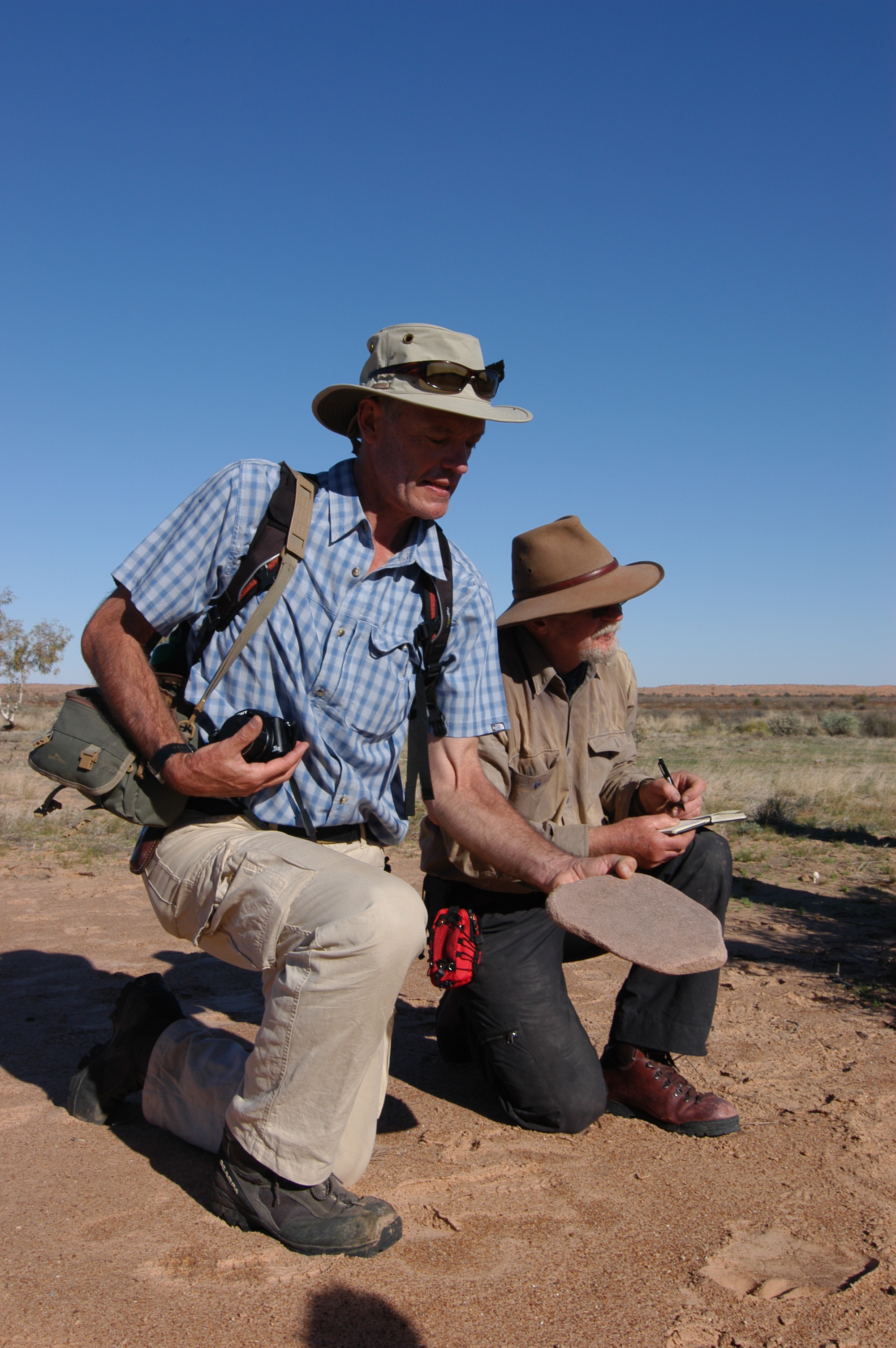 Dr's Philip Jones and Mike Smith examine artefacts.