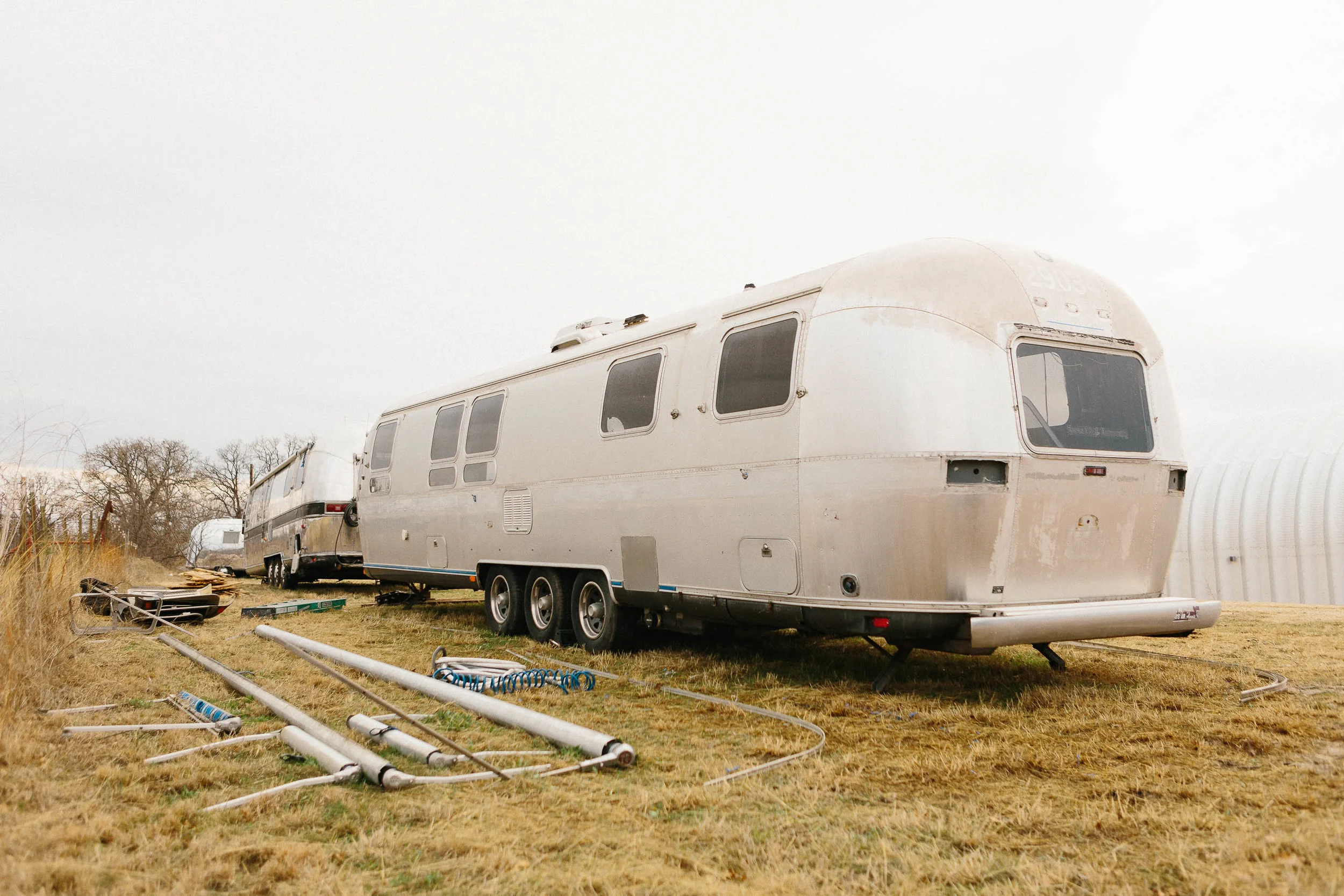The five awnings removed. Behind them to the left of the frame are the gravel guards, the "sunglasses" (that protect the front panoramic window), the battery boxes, and the propane tank cover.