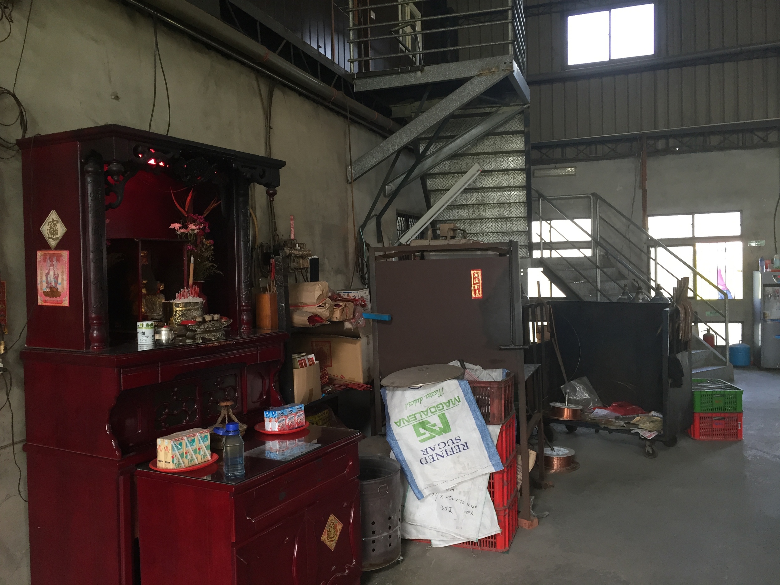 I couldn't tell what was up the stairs. Just behind them is a TIG welding area, and to the right is the front door, which opens to the street.
