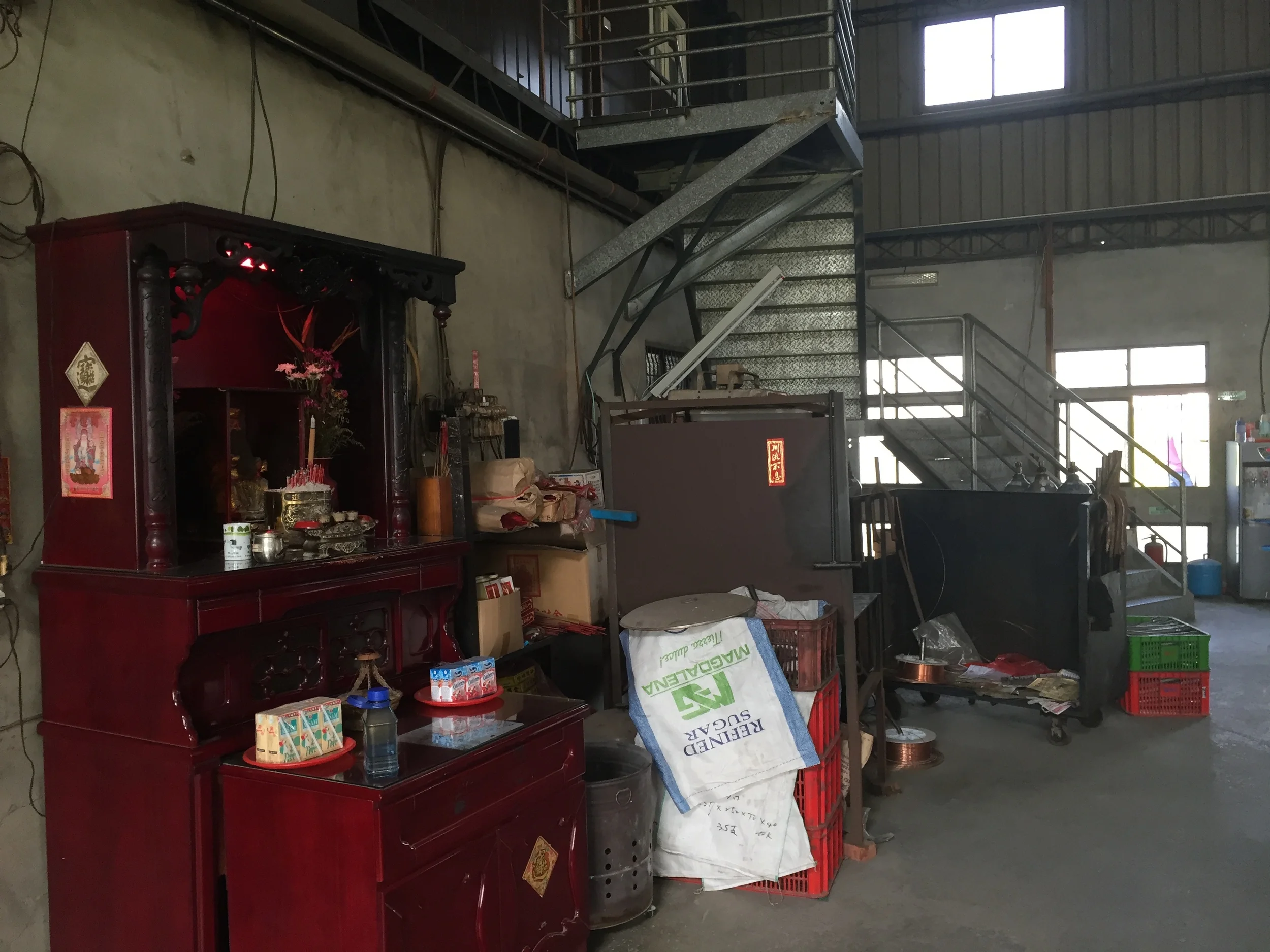 I couldn't tell what was up the stairs. Just behind them is a TIG welding area, and to the right is the front door, which opens to the street.