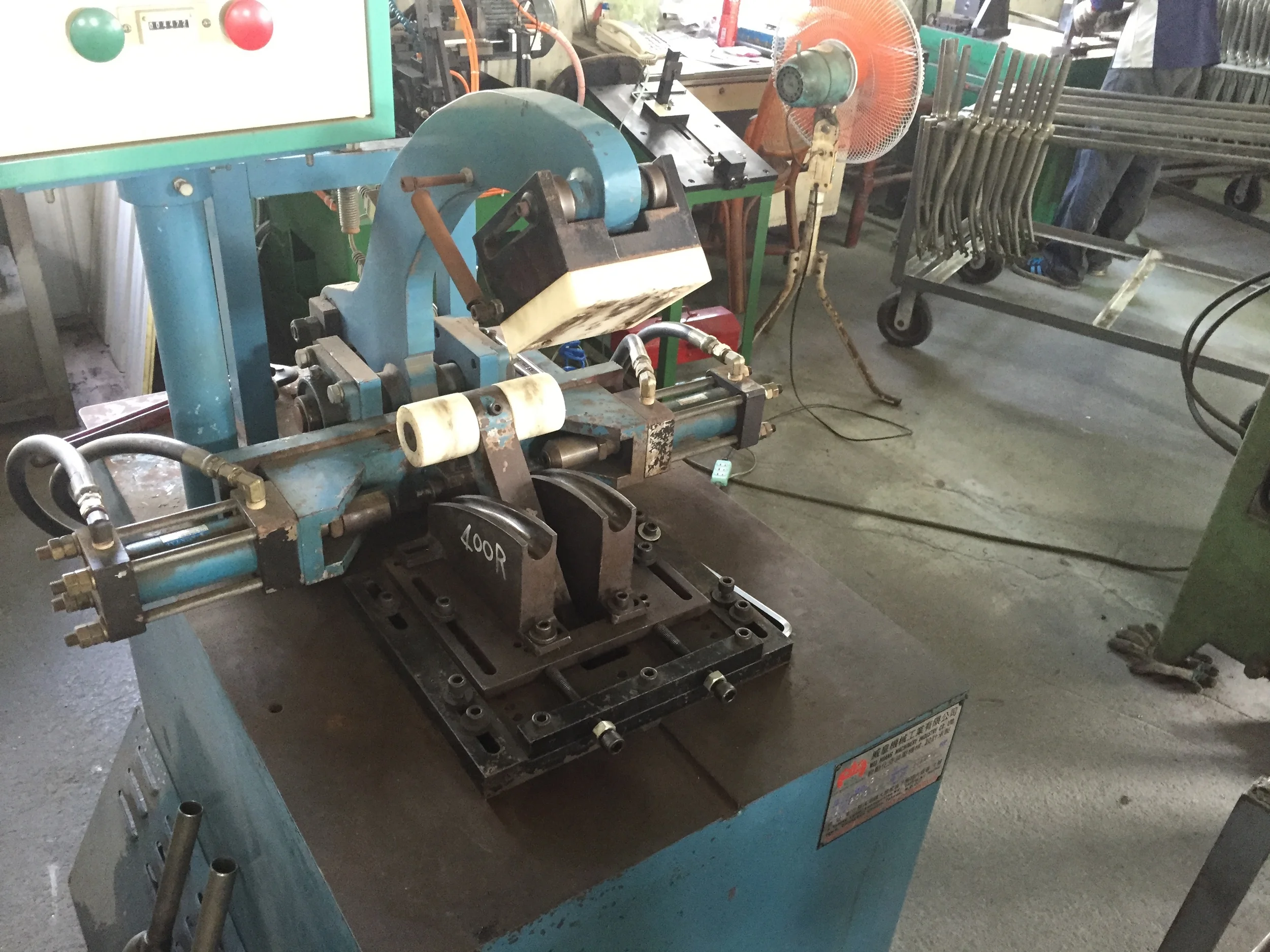 This fork raking machine is awesome. The dropouts clip in at the front, and are held in place by big plastic blocks. Then the top arm comes down, pushing the upper section of the blades down onto the bending dies.