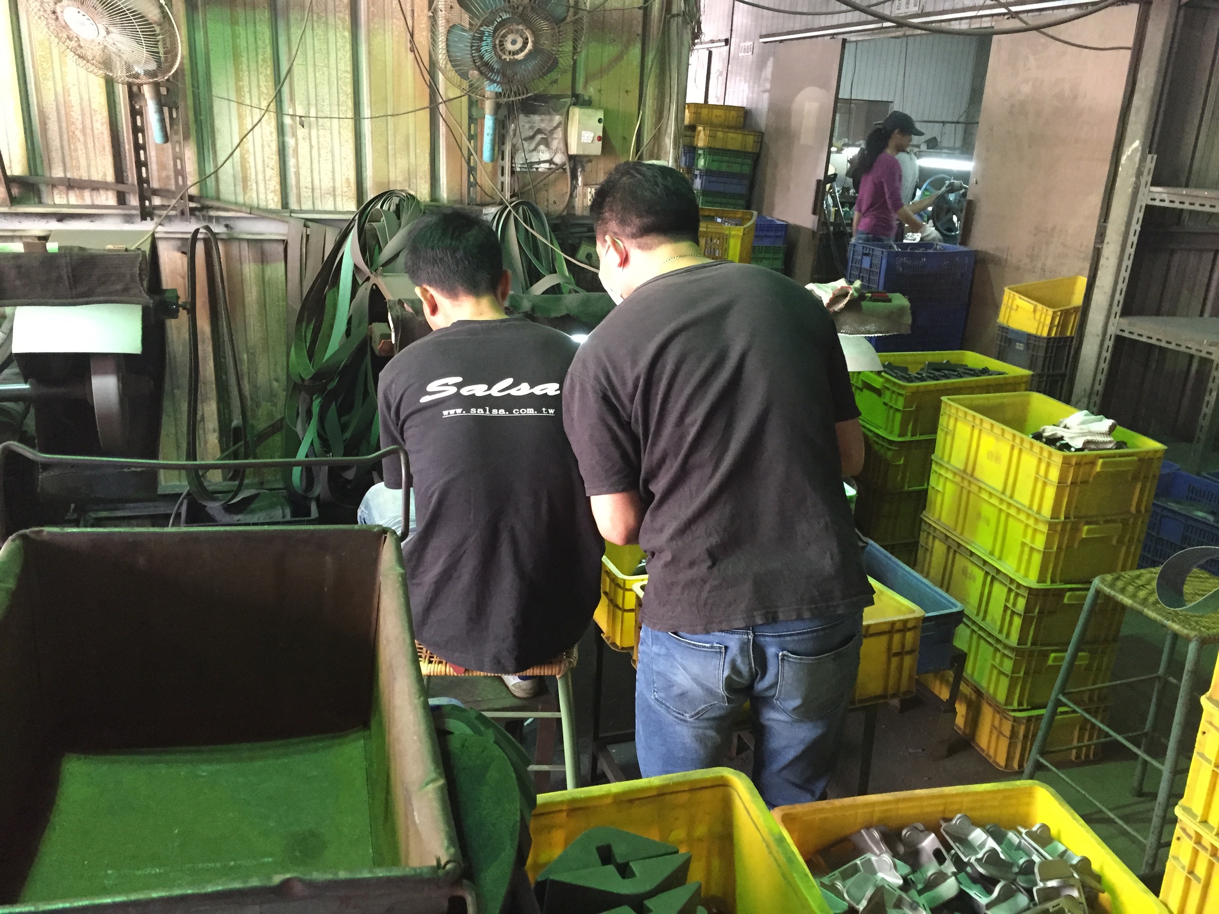 Part grinding. You still need to clean the parts a bit after you cut them from the trees; these guys were sitting at grinders doing that.