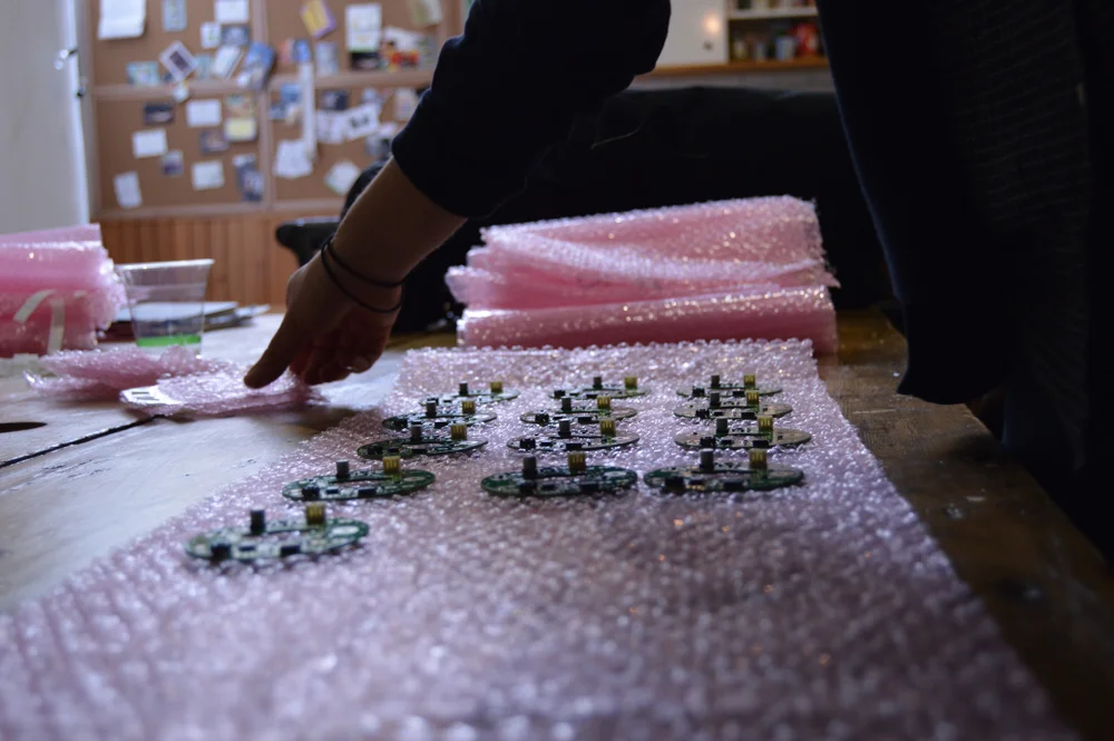 Packaging printed circuit boards in antistatic bubble wrap bags. Our PCBs are the most valuable item on our BOM, and we want to make sure they stay protected.