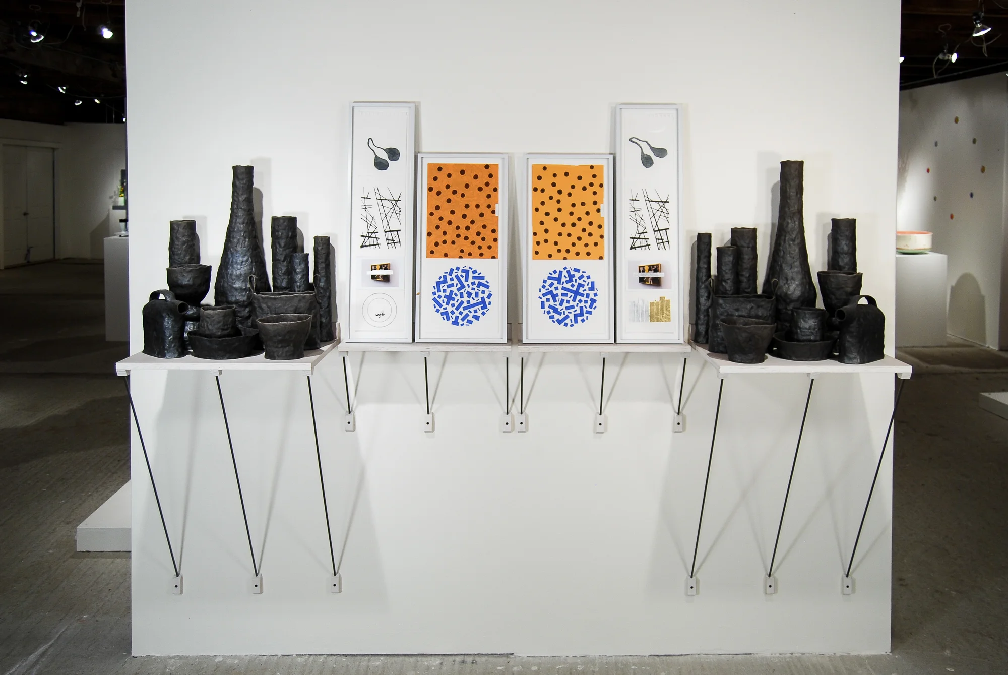 Between One and The Same—Part 2 | 2011 Raku-fired earthenware, mixed media on paper, frames, dyed plywood, steel supports, misc. fasteners. 86 inches wide.