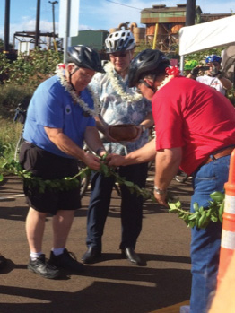 Pastor Lucky Ka’ahumanu blows the conch shell while Maui County Councilmember Don Couch, Managing Director Keith Regan and Councilmember Mike Victorino untie the ceremonial maile lei.