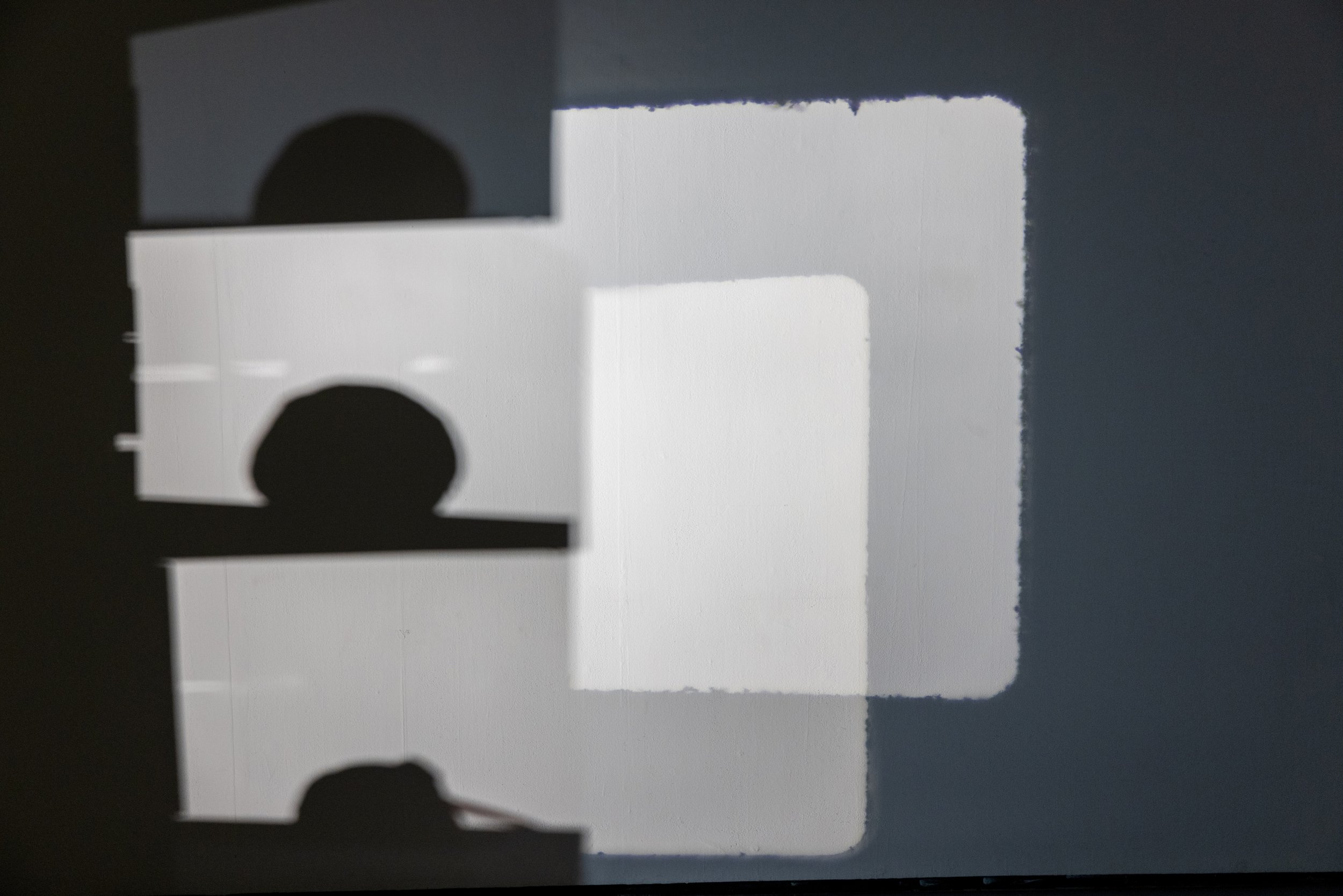   HEAD de-archival feed,  &amp;  On Cabbage,  2024.  still of Single-channel video collage, 34:50 loop, Birch plywood, 16 mm celluloid film, resin cast of cabbage, vegetable oil, 16 mm Eiki film projector, 16 mm Eiki film projector light, found mater